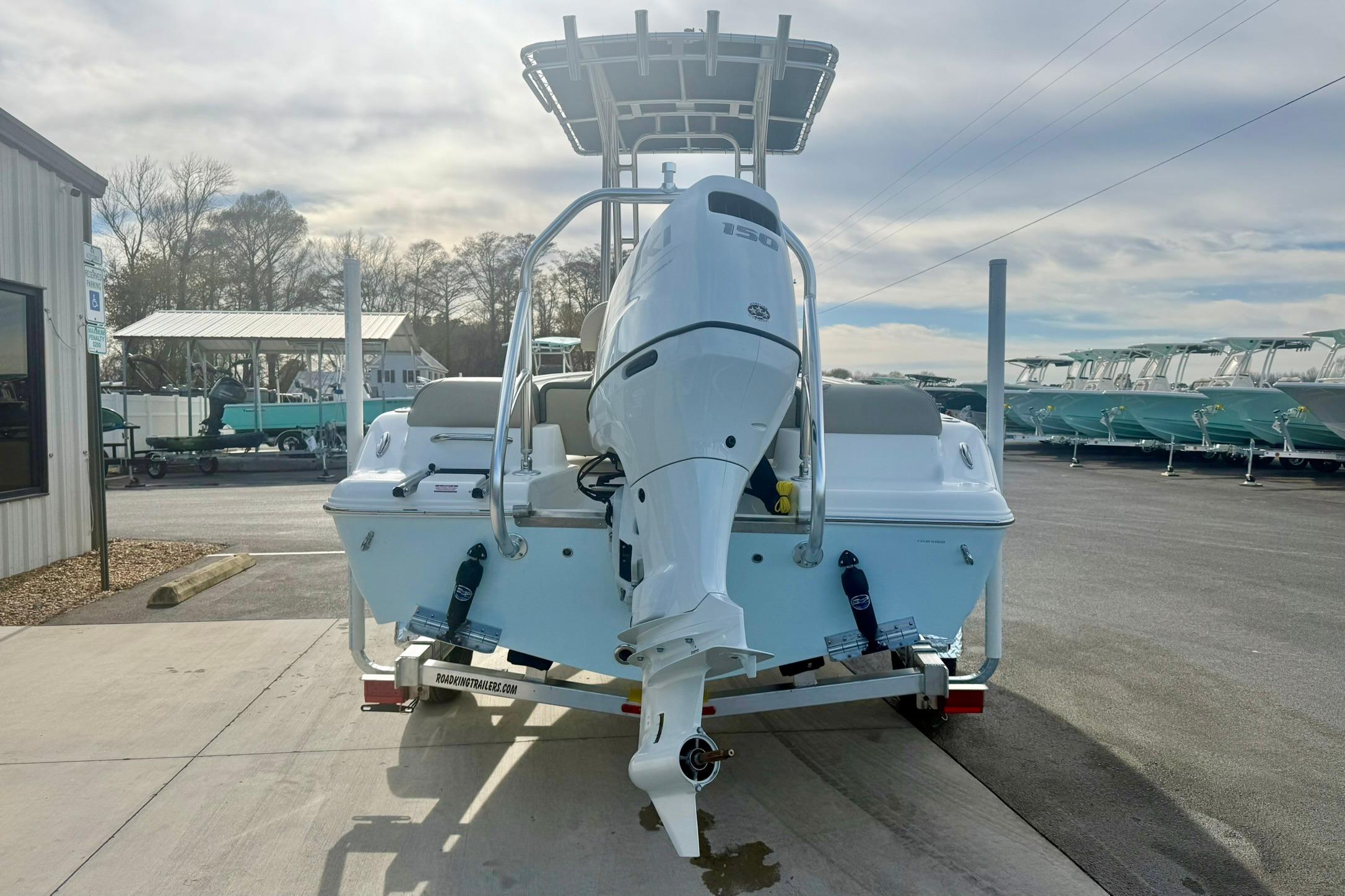 2026 Key West 189 FS boat with outboard motor on trailer in marina.