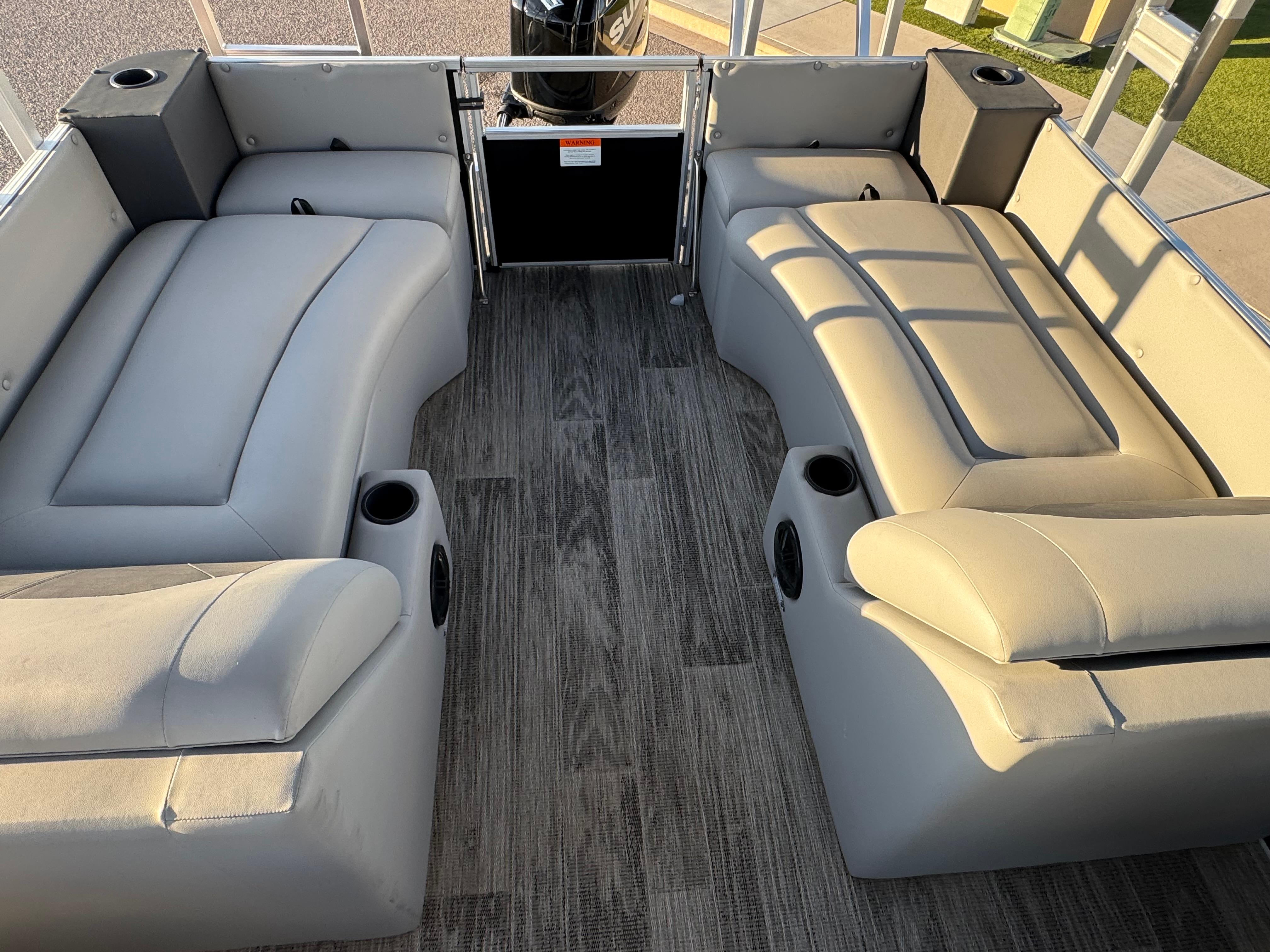 2024 Landau Island Breeze 252 pontoon boat interior with gray seating and wood-style flooring.