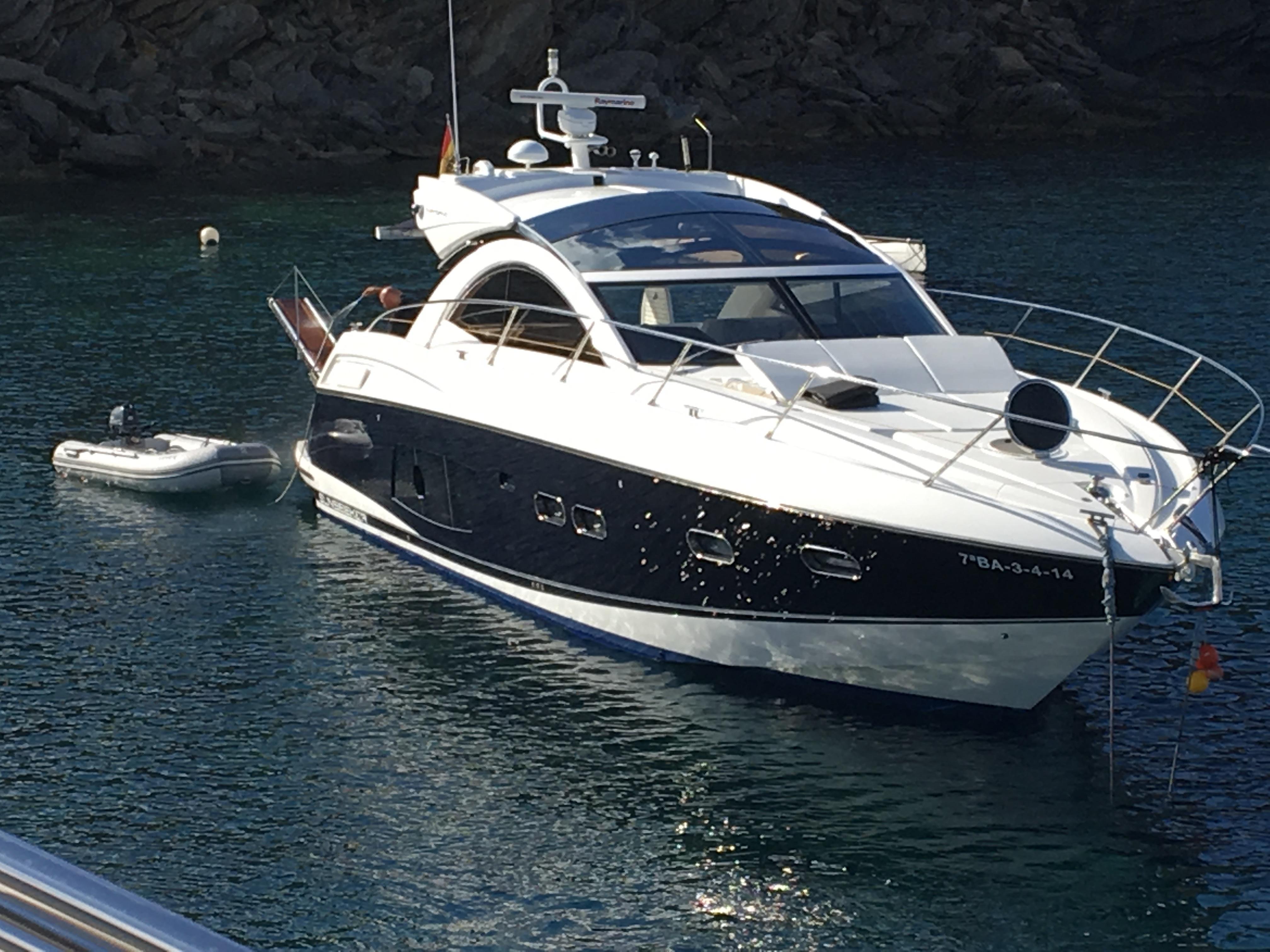 2012 Sunseeker Portofino 48 yacht anchored in calm waters.