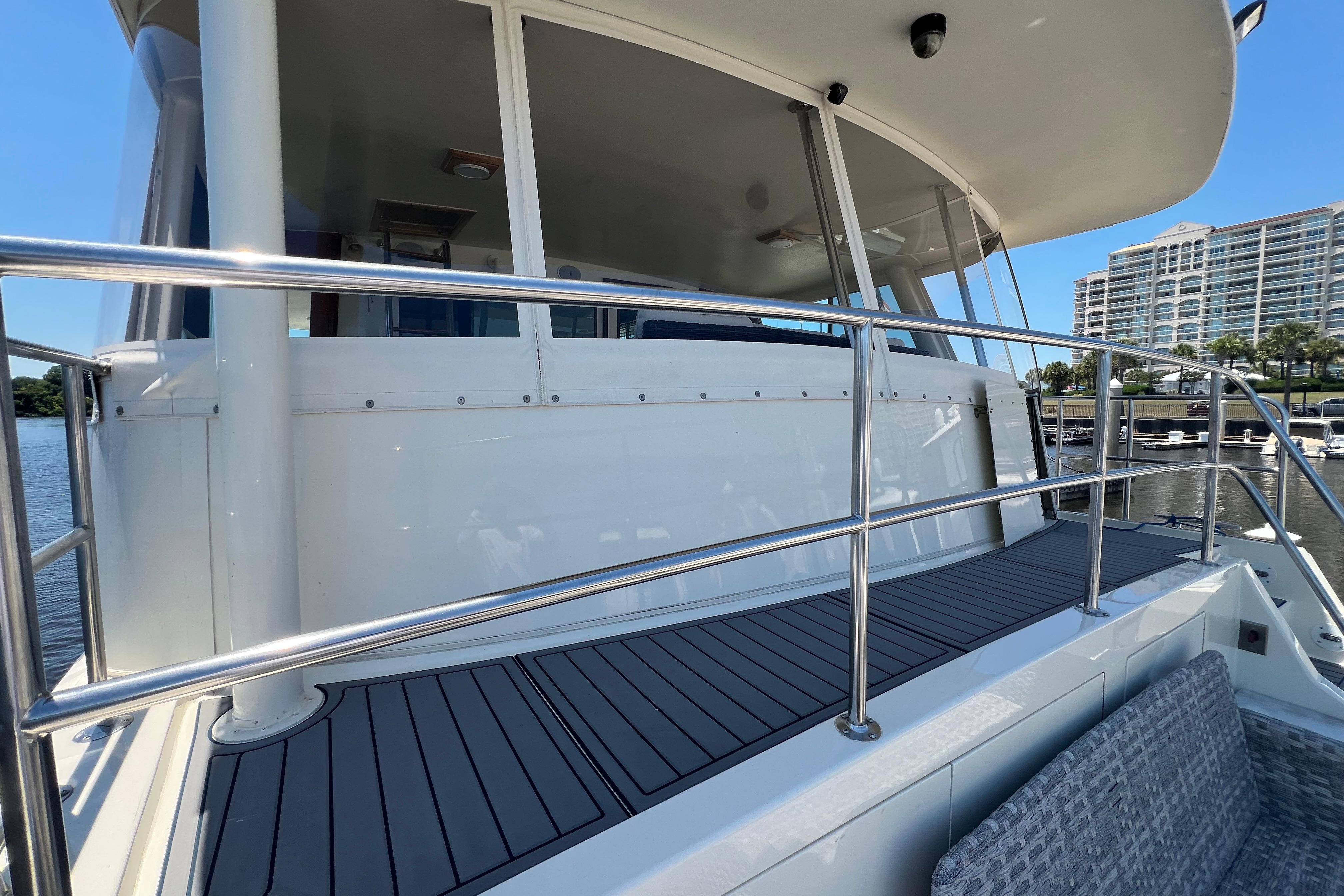 1987 Hatteras 70 Cockpit Motor Yacht deck with railing and marina view.