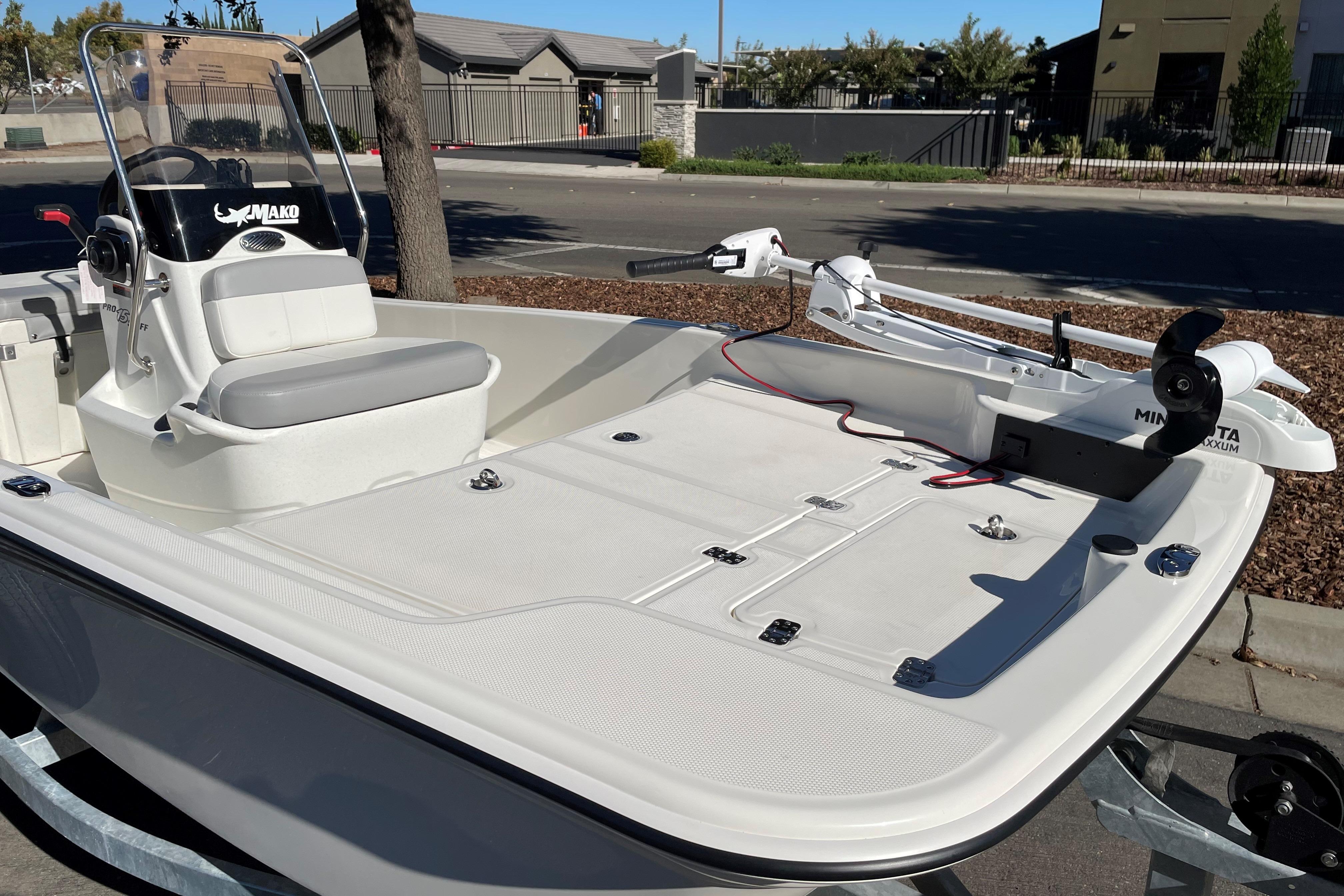 2025 Mako Pro Skiff 15 CC boat with Minn Kota trolling motor, parked on a trailer.