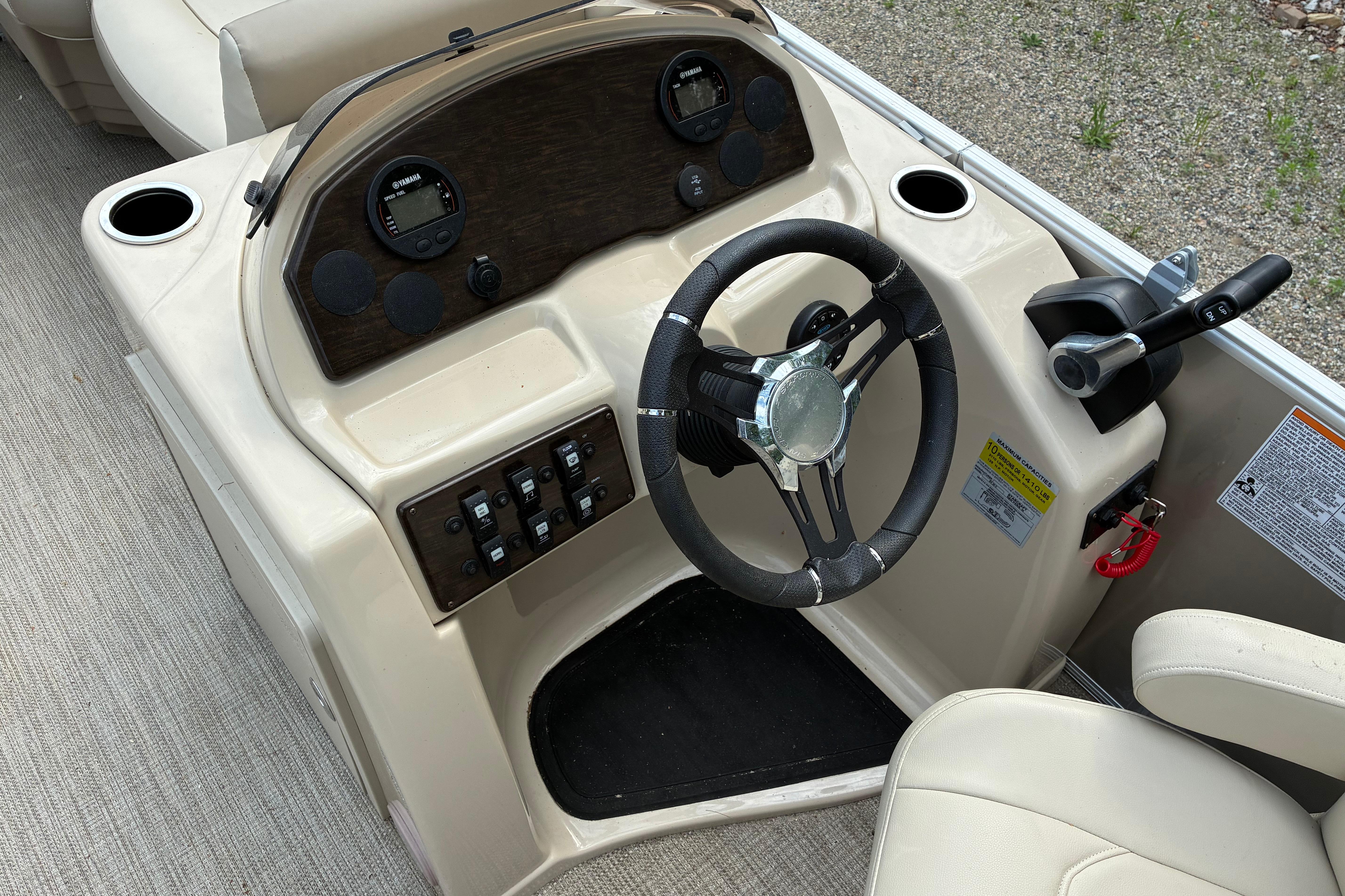 Steering console of a 2020 Starcraft EX 20 C boat with controls and gauges.