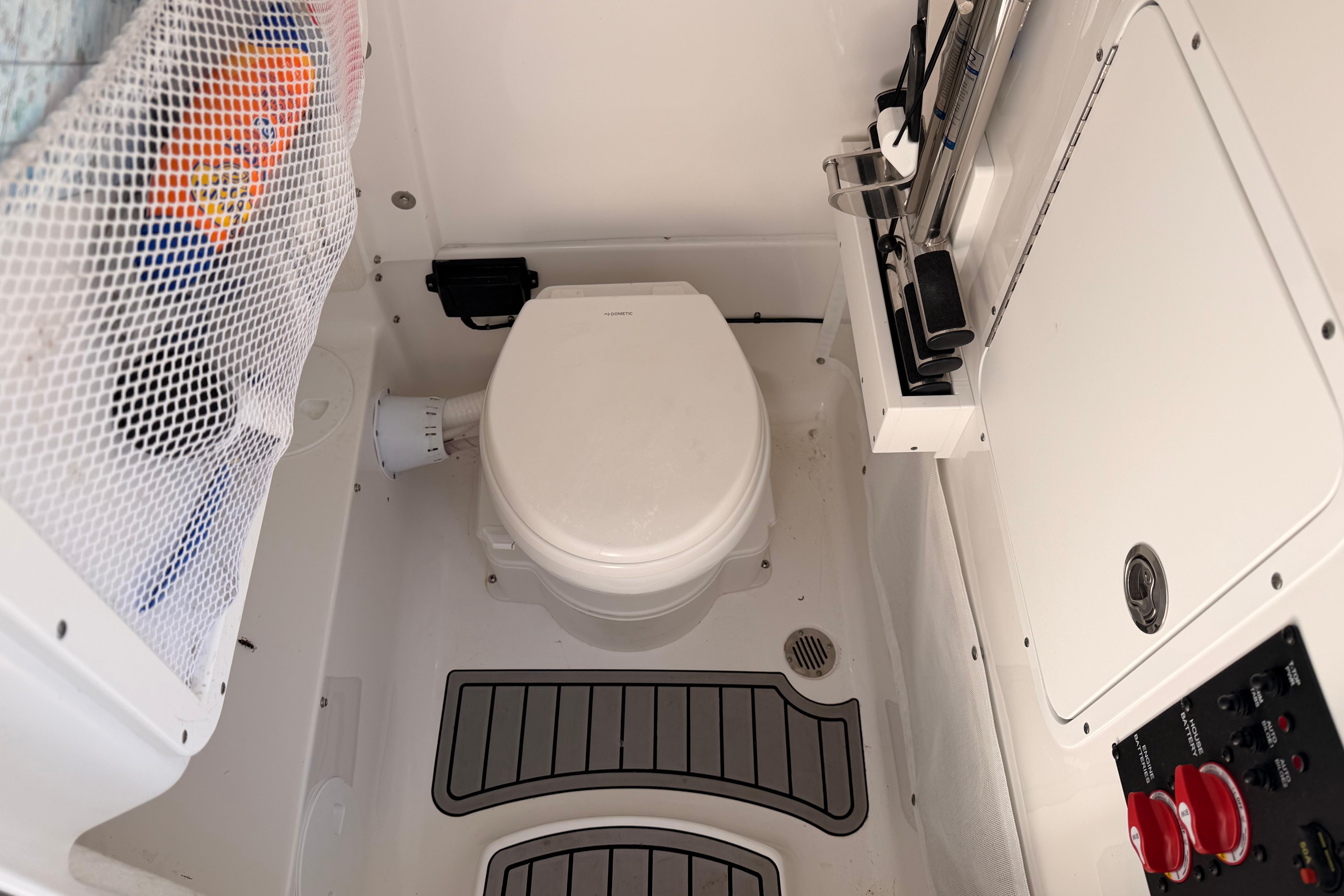 2024 Sea Hunt Gamefish 27 Coffin Box boat interior with toilet and storage features.