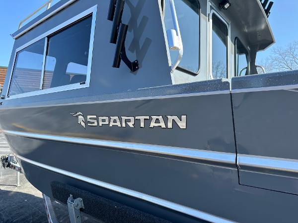 2024 Spartan 260 Maximus Pro XL boat side view with logo.