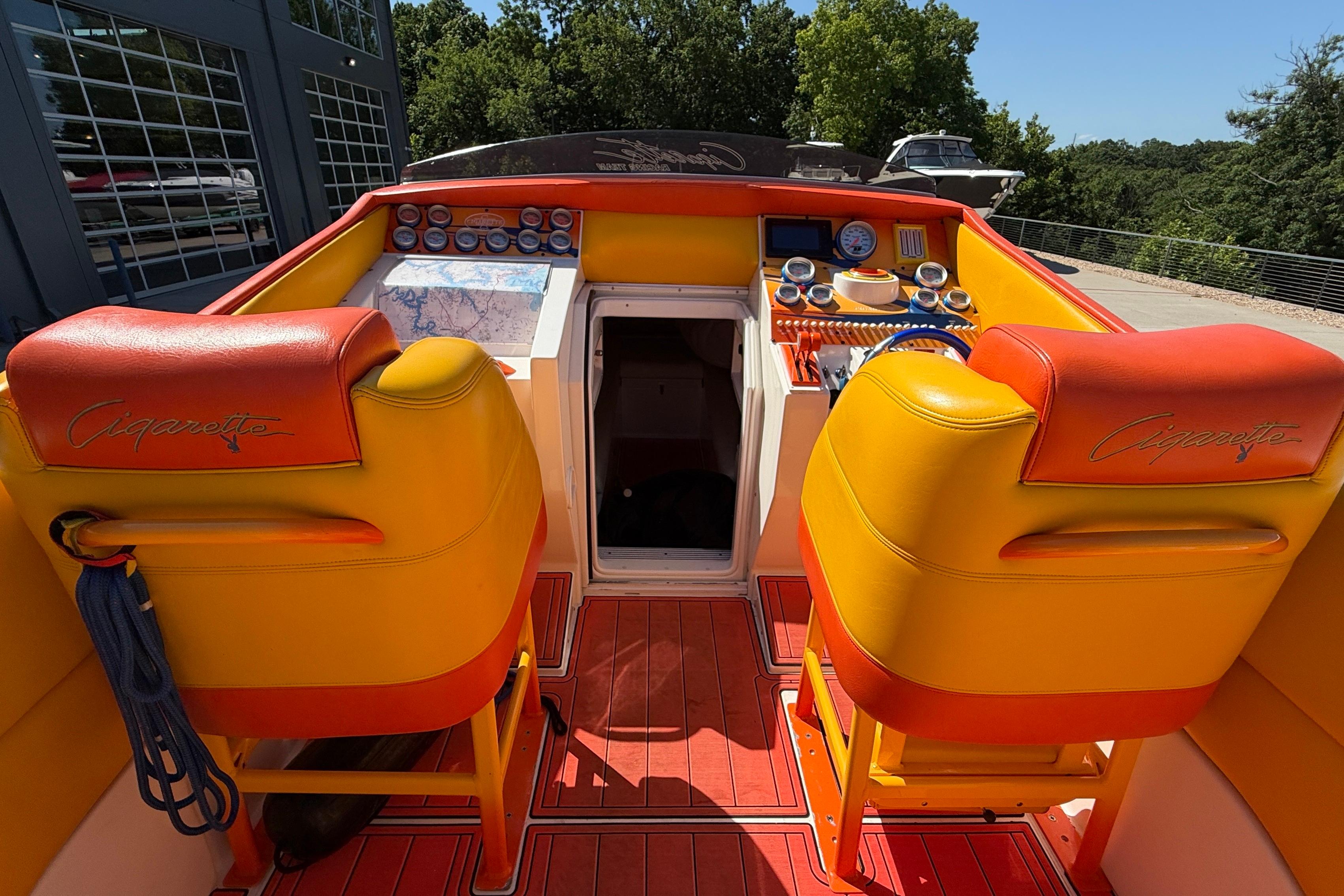 2002 Cigarette 35' Cafe Racer boat interior with vibrant orange and yellow seating.