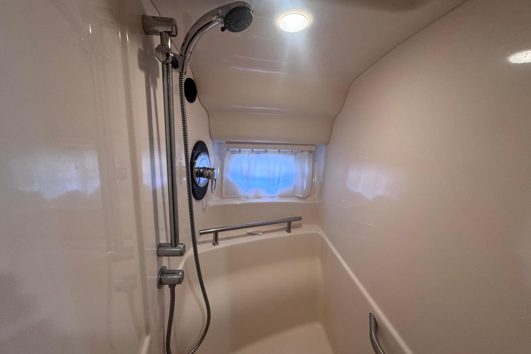 Shower area in 2004 Sea Ray 390 Sundancer yacht with handheld showerhead.
