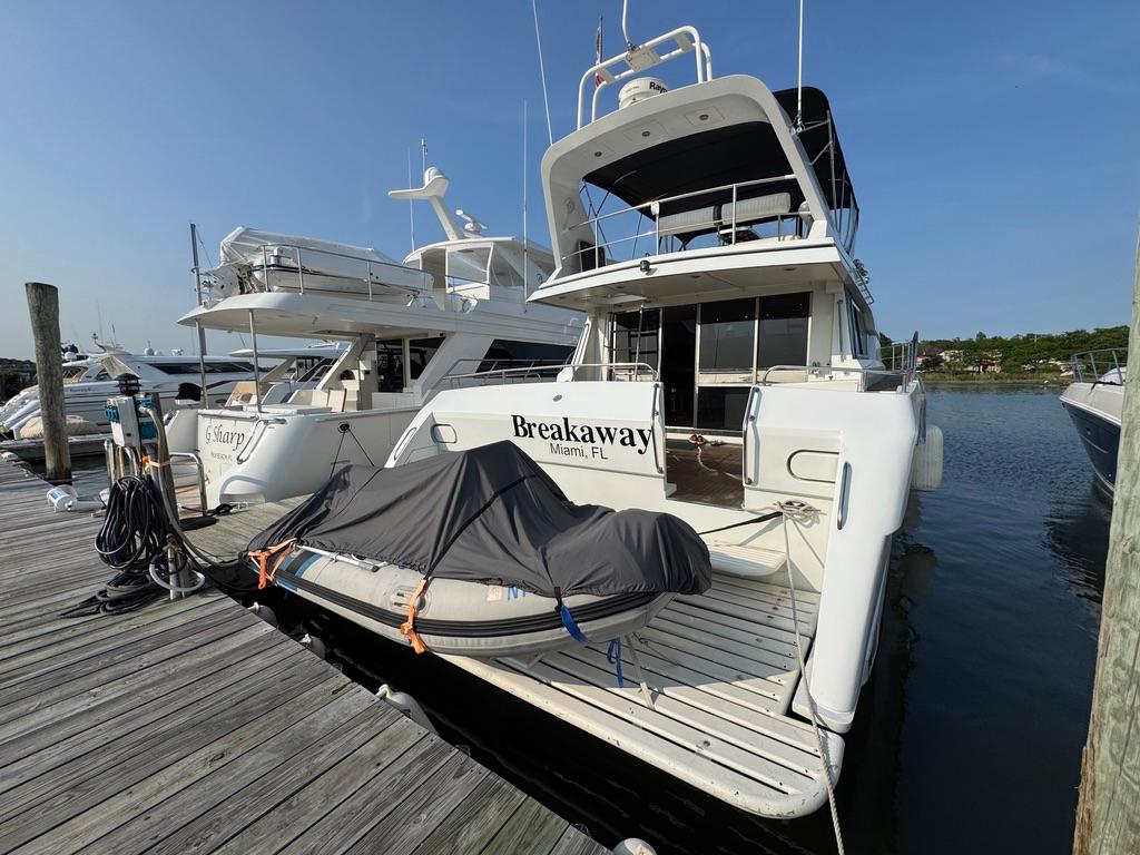 1989 Birchwood 62 Cockpit Motor Yacht docked, featuring covered equipment on the deck.