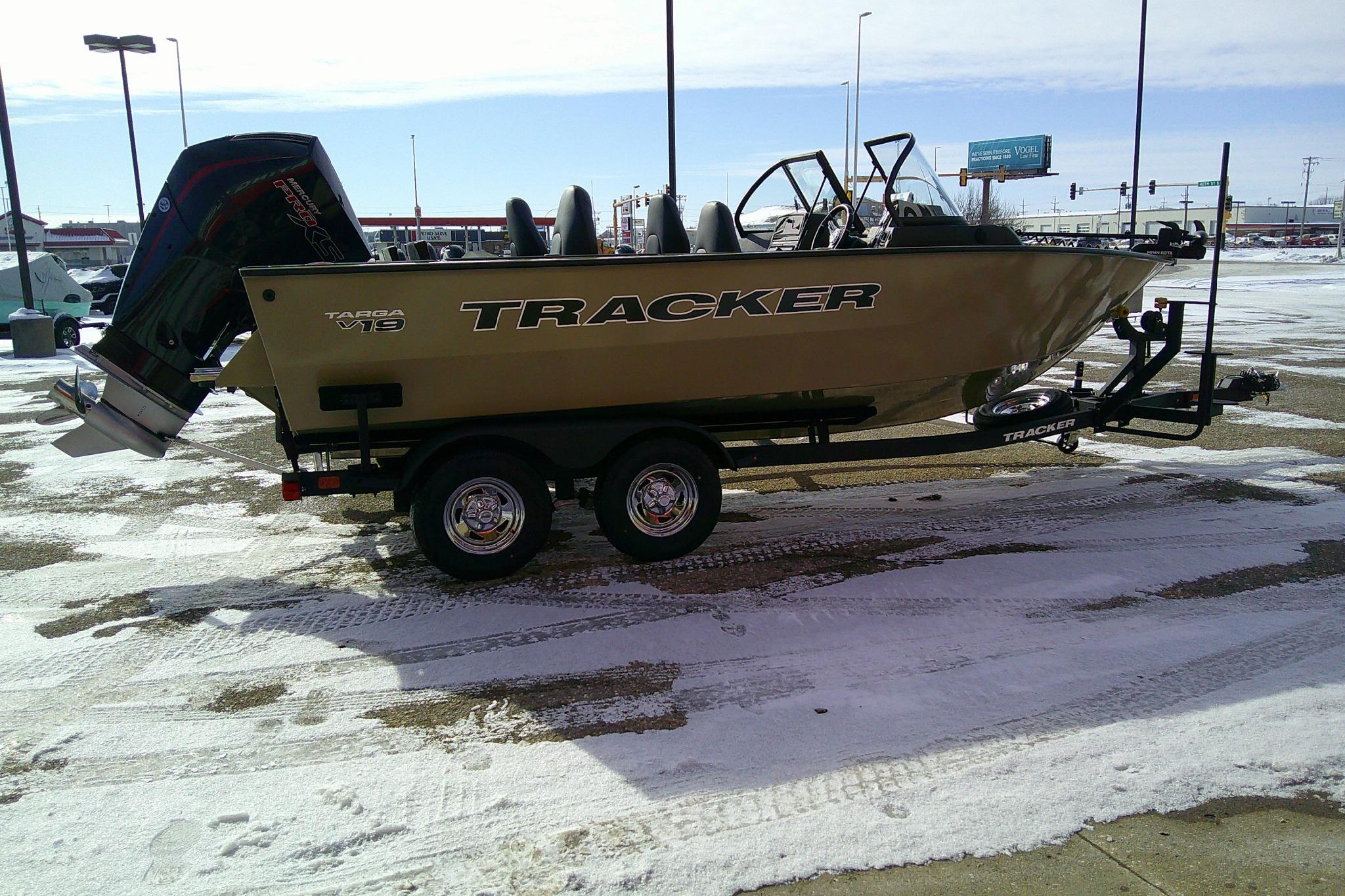 2026 Tracker Targa V-19 Combo boat on trailer in snowy parking lot.