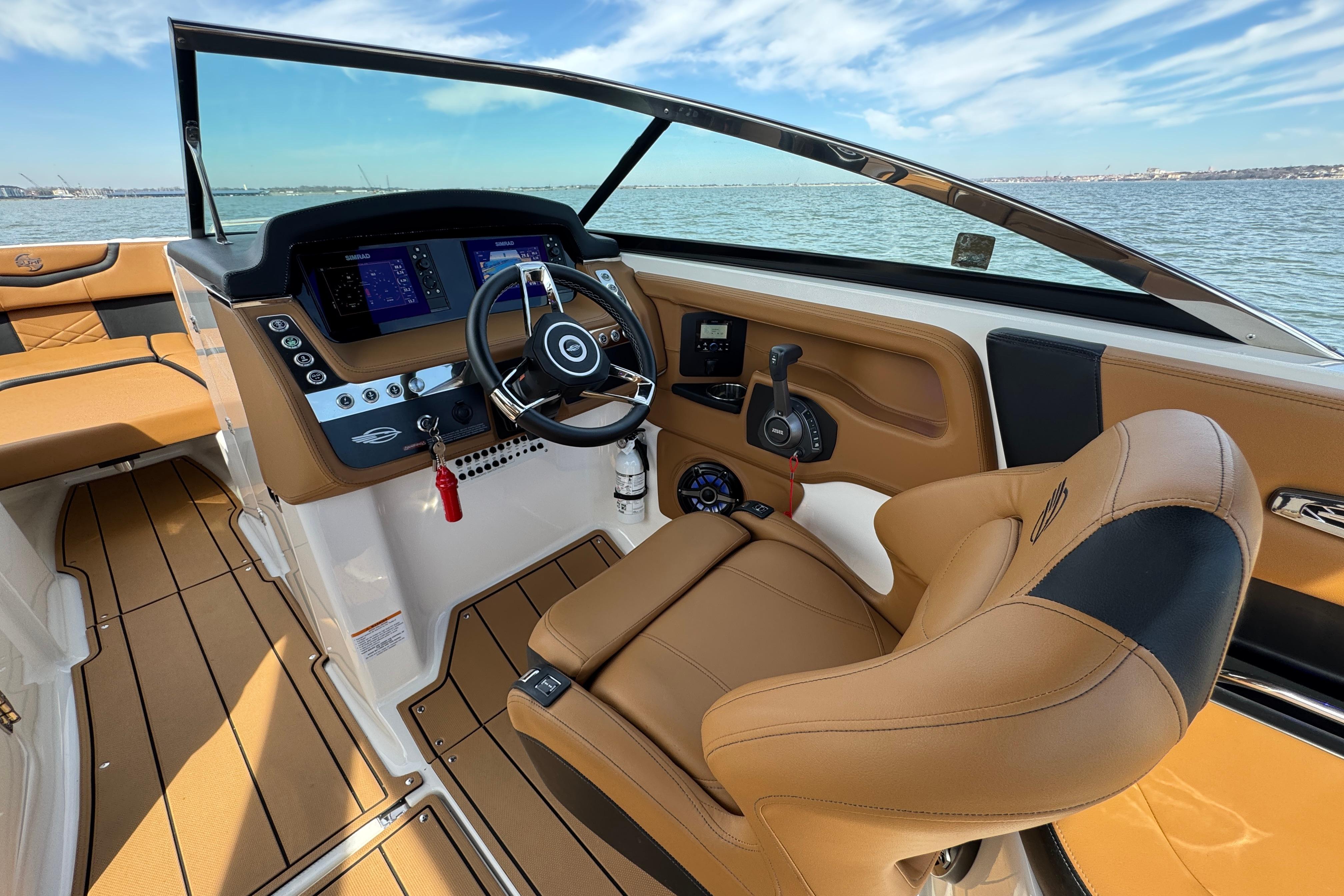 2023 Chaparral 26 Surf boat interior with modern dashboard and luxurious seating.