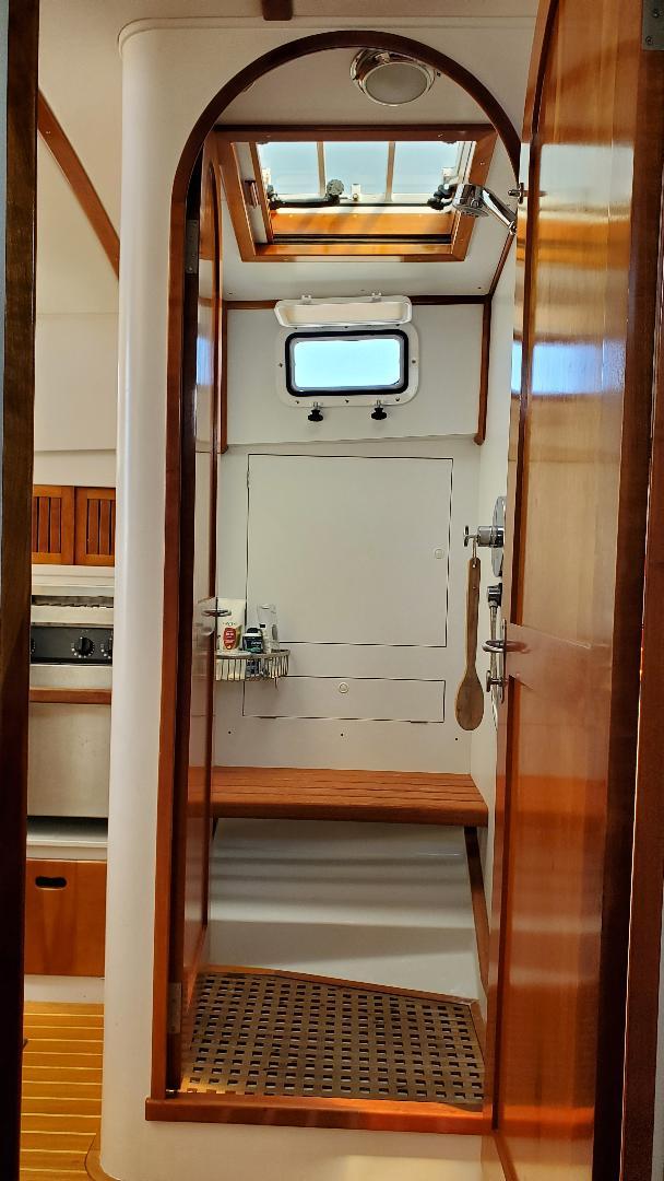 Interior of 1997 Lyman-Morse Custom Flybridge yacht with wooden accents and skylight.