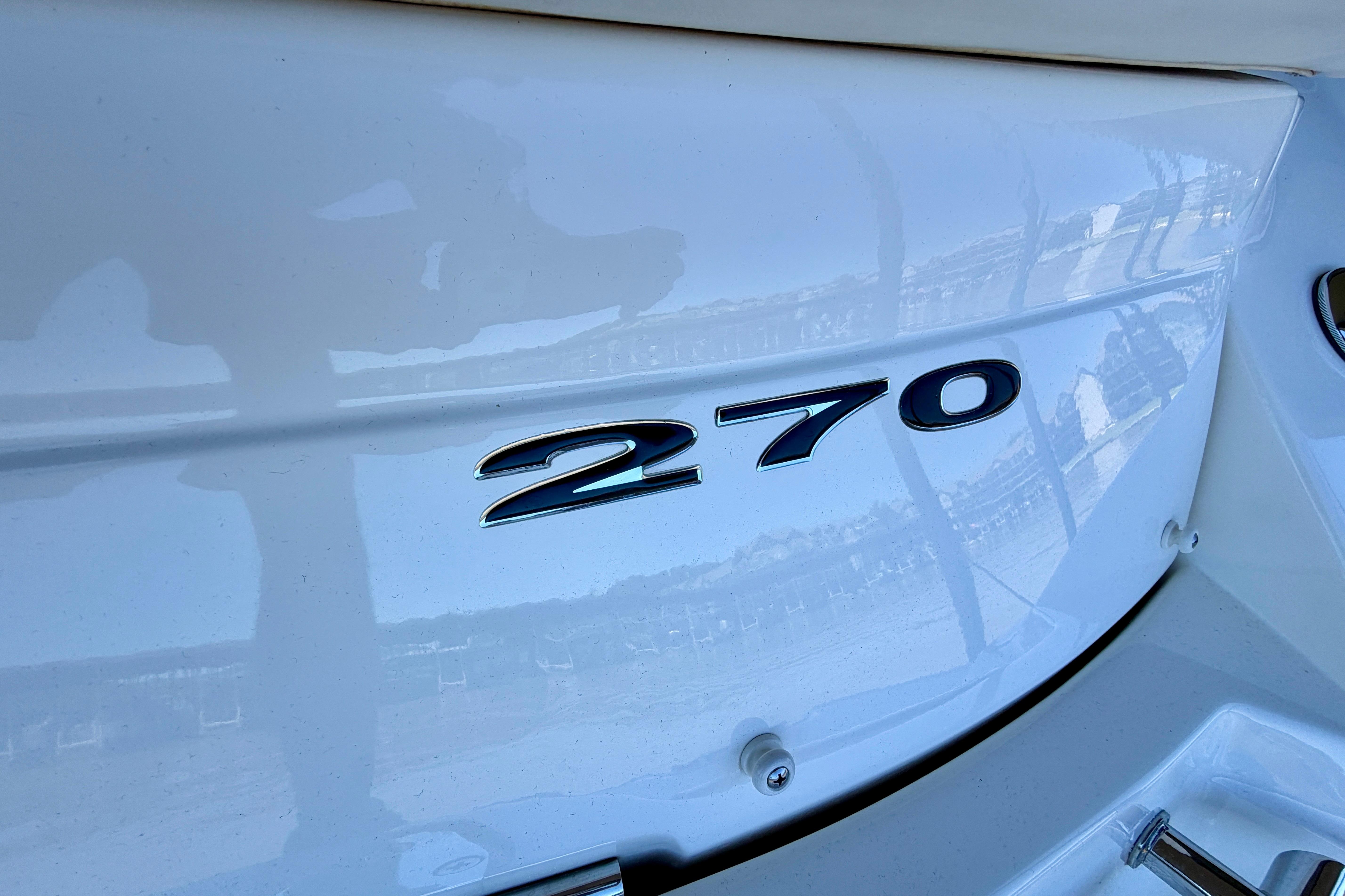 Close-up of 2007 Sea Ray 270 SLX boat model emblem.