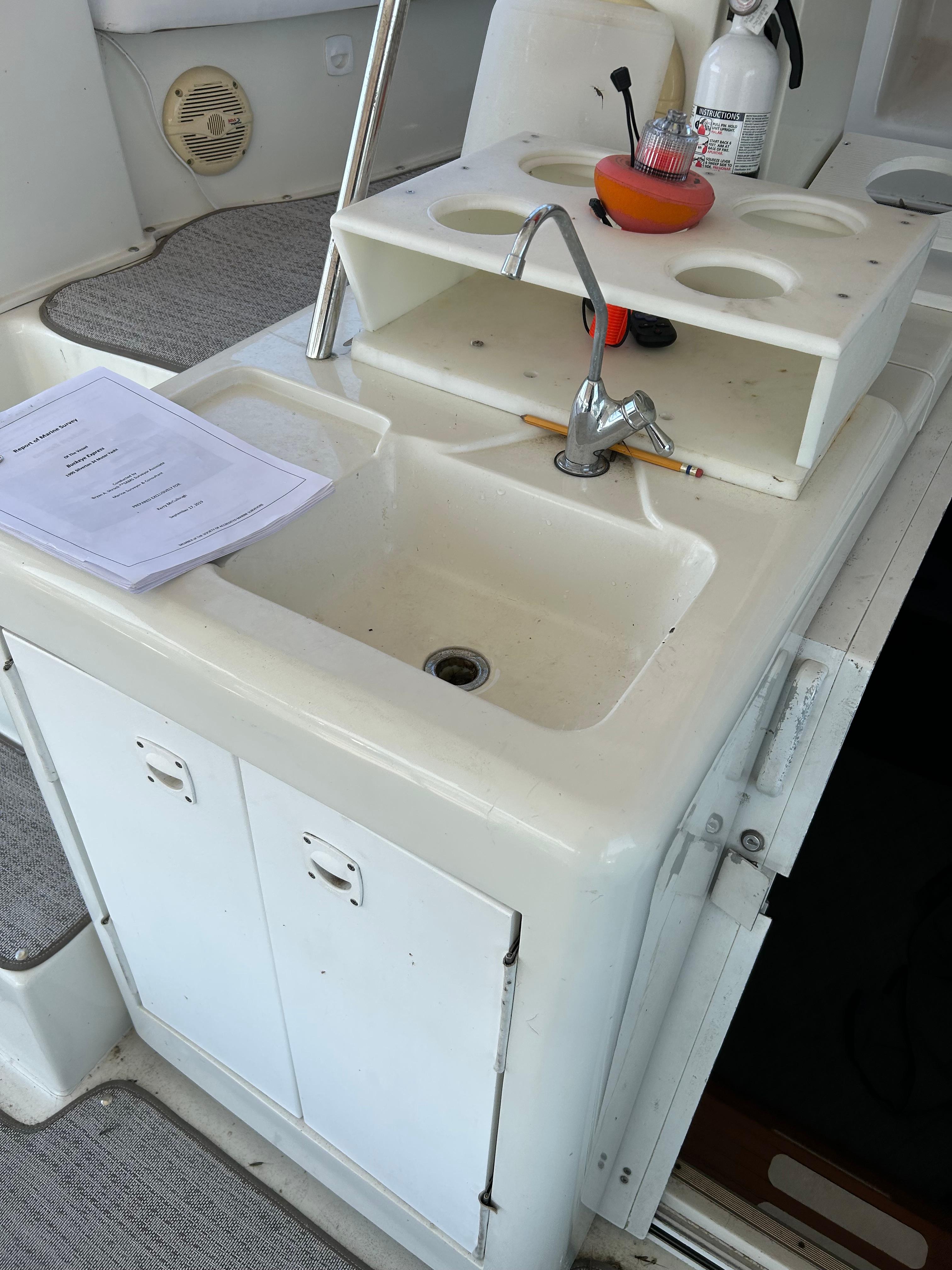 1995 Silverton AFT CABIN boat sink area with faucet and storage.