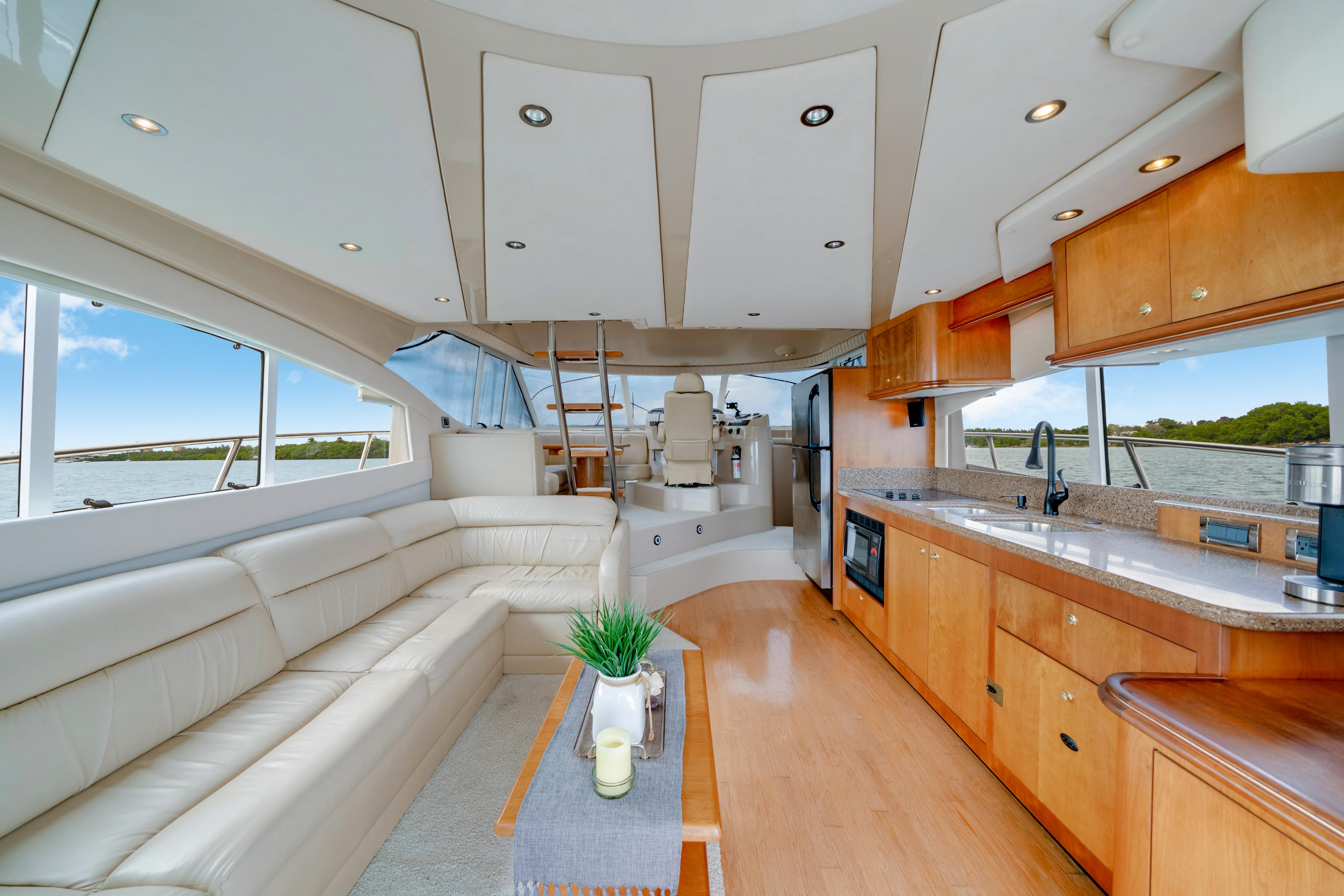 Luxurious interior of 2001 Cruisers Yachts 5000 Sedan Sport with modern kitchen and seating area.