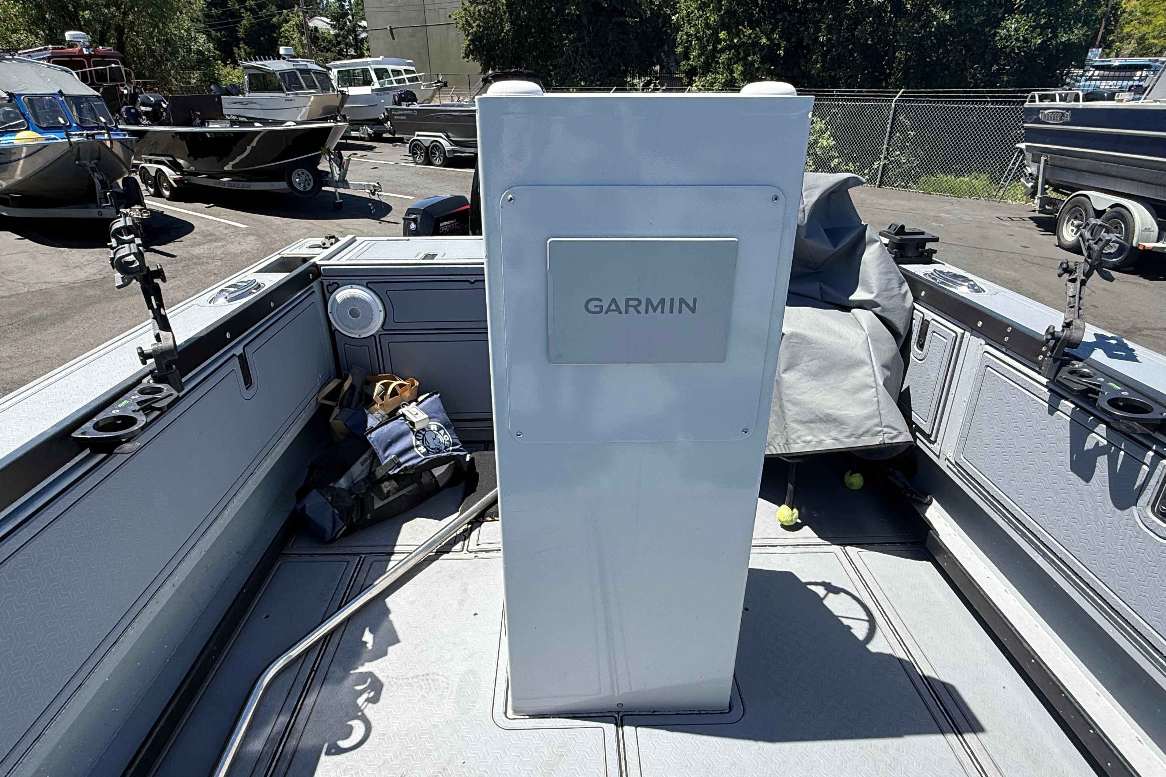 2015 Alumaweld Pacific XD 28 boat interior with Garmin equipment, docked outdoors.