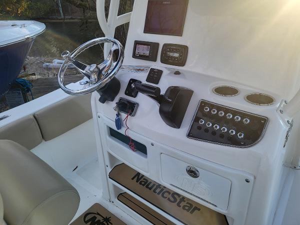 2021 NauticStar 2302 Legacy boat console with steering wheel, controls, and navigation equipment.