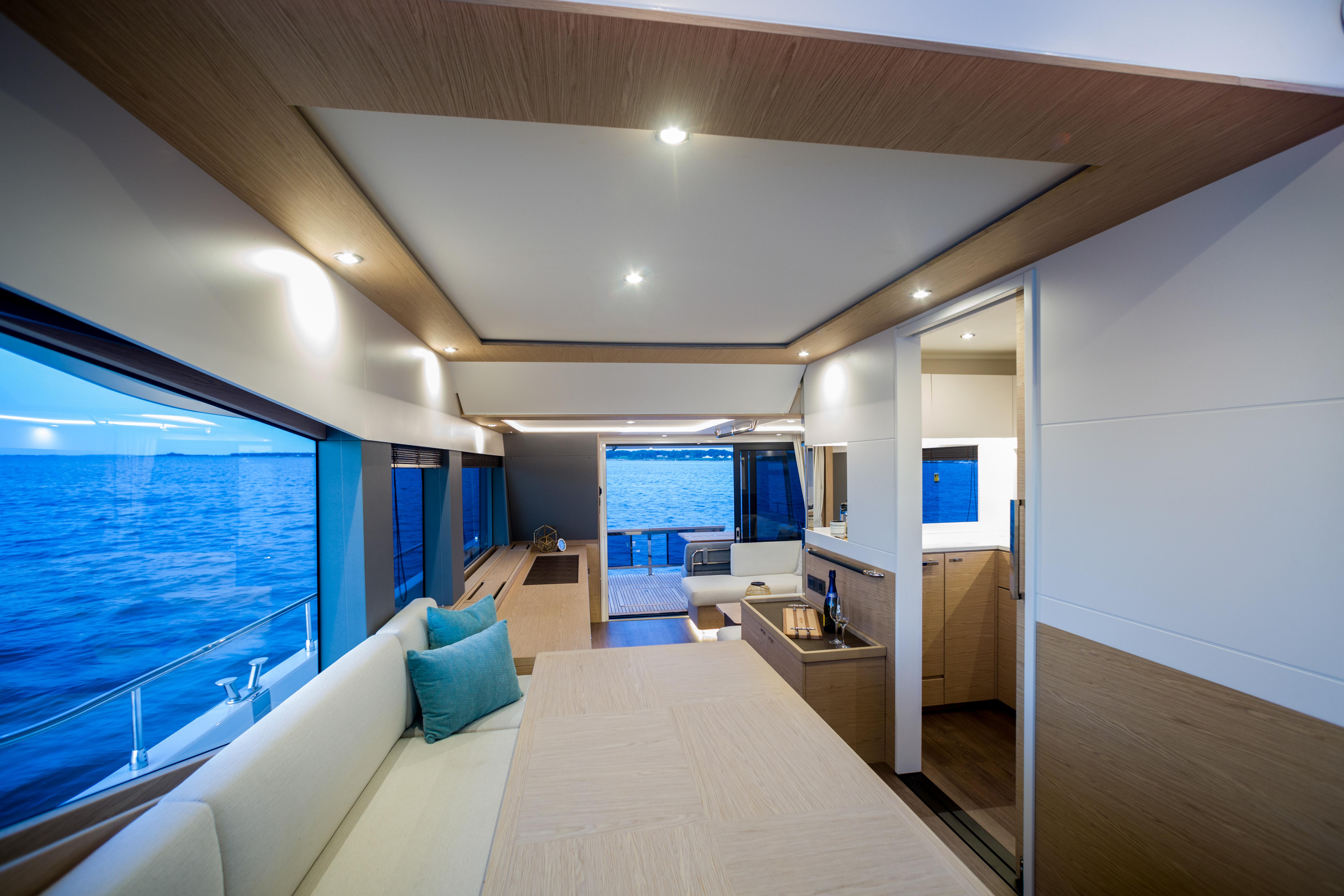 Luxurious interior of 2025 Beneteau Grand Trawler 62 yacht with ocean view.