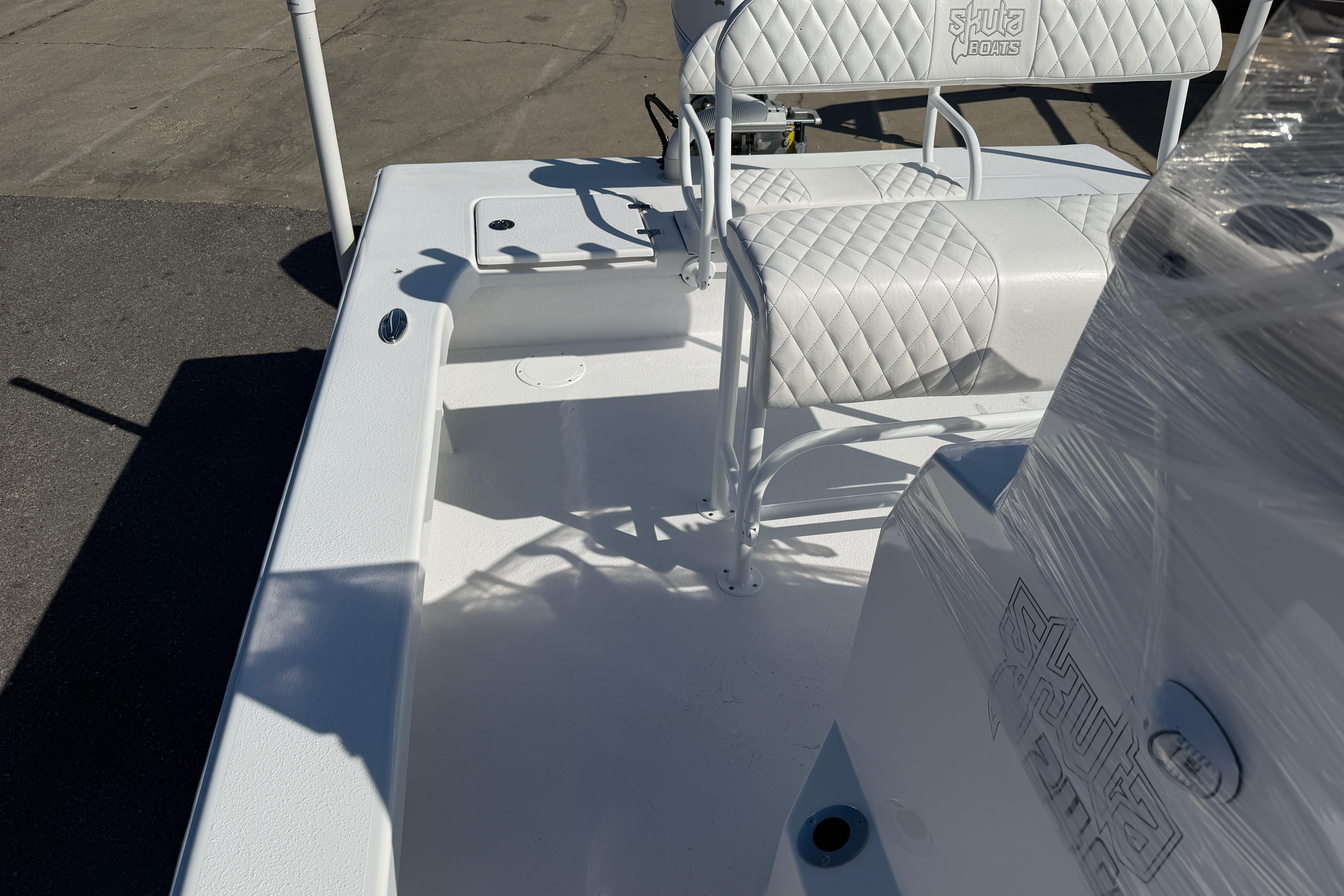 2026 Skuta 24 Cat boat interior with quilted seating and sleek design.