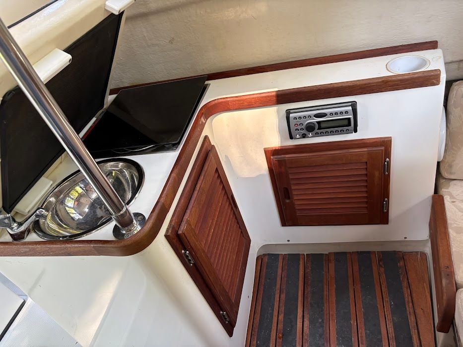 Interior of a 2007 Ranger Tugs R-21 EC with wood paneling and stainless steel sink.