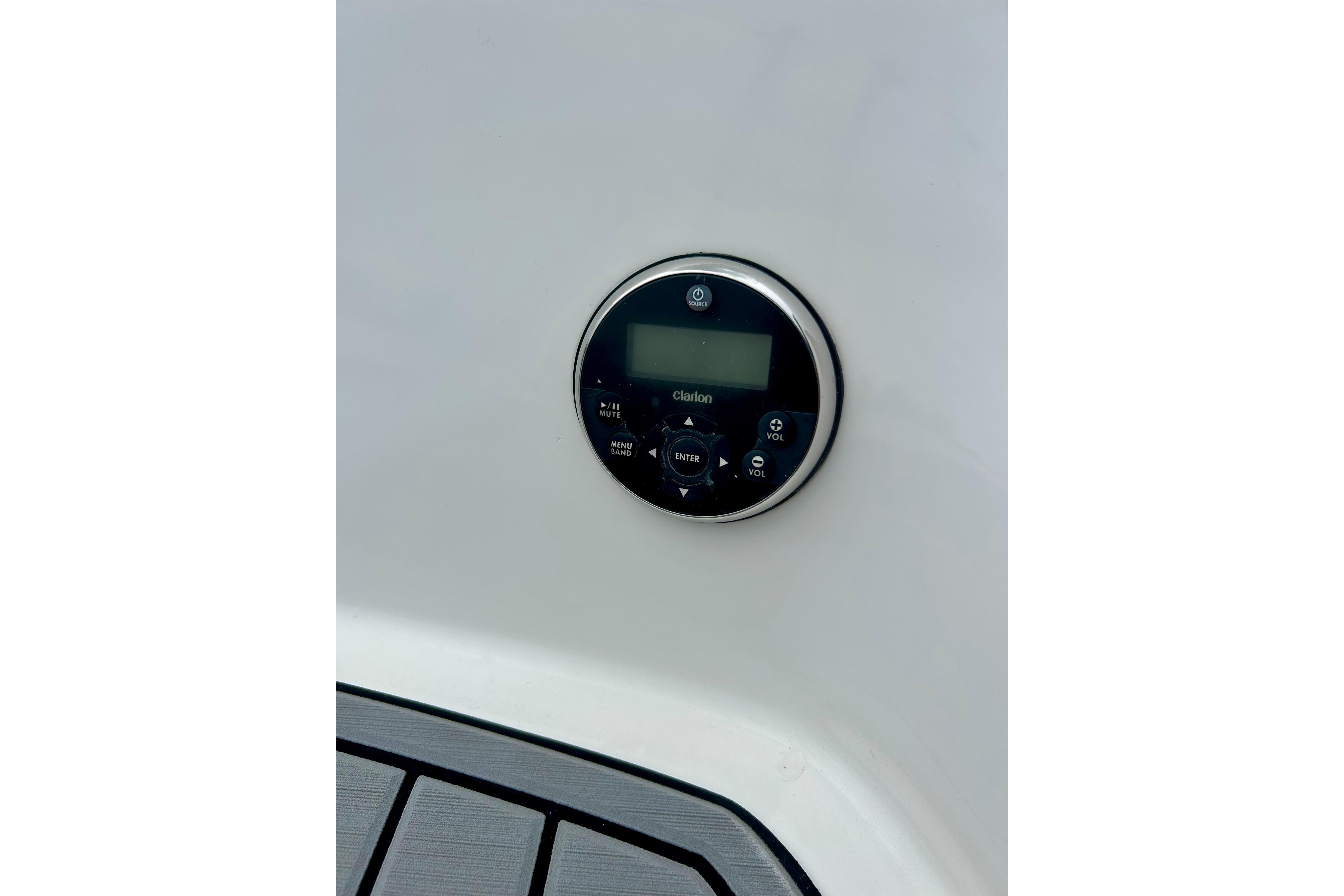 Control panel on 2015 Yamaha AR210 boat, featuring Clarion audio system.