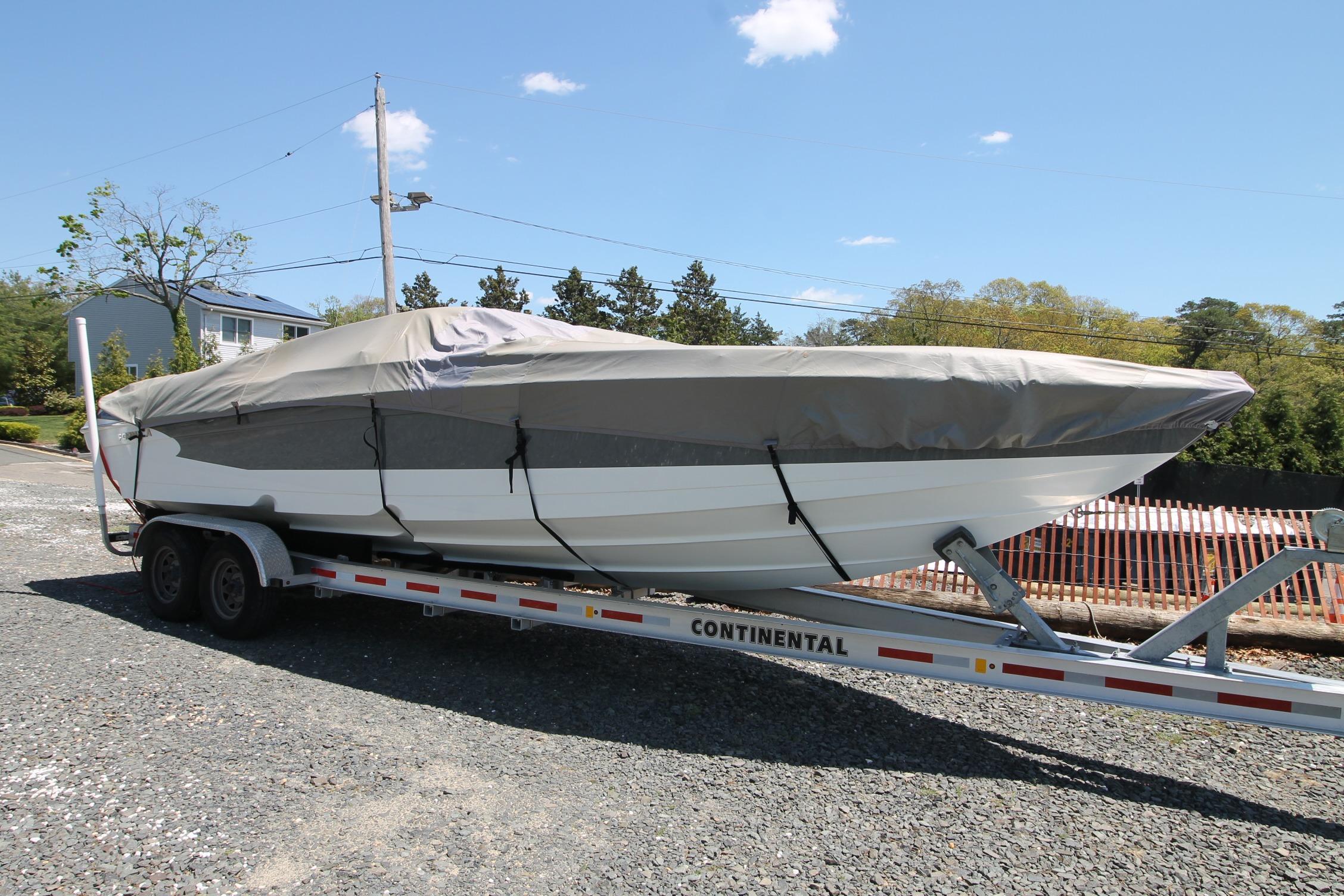 2006 Formula 292 FASTech boat covered on trailer, parked outdoors.