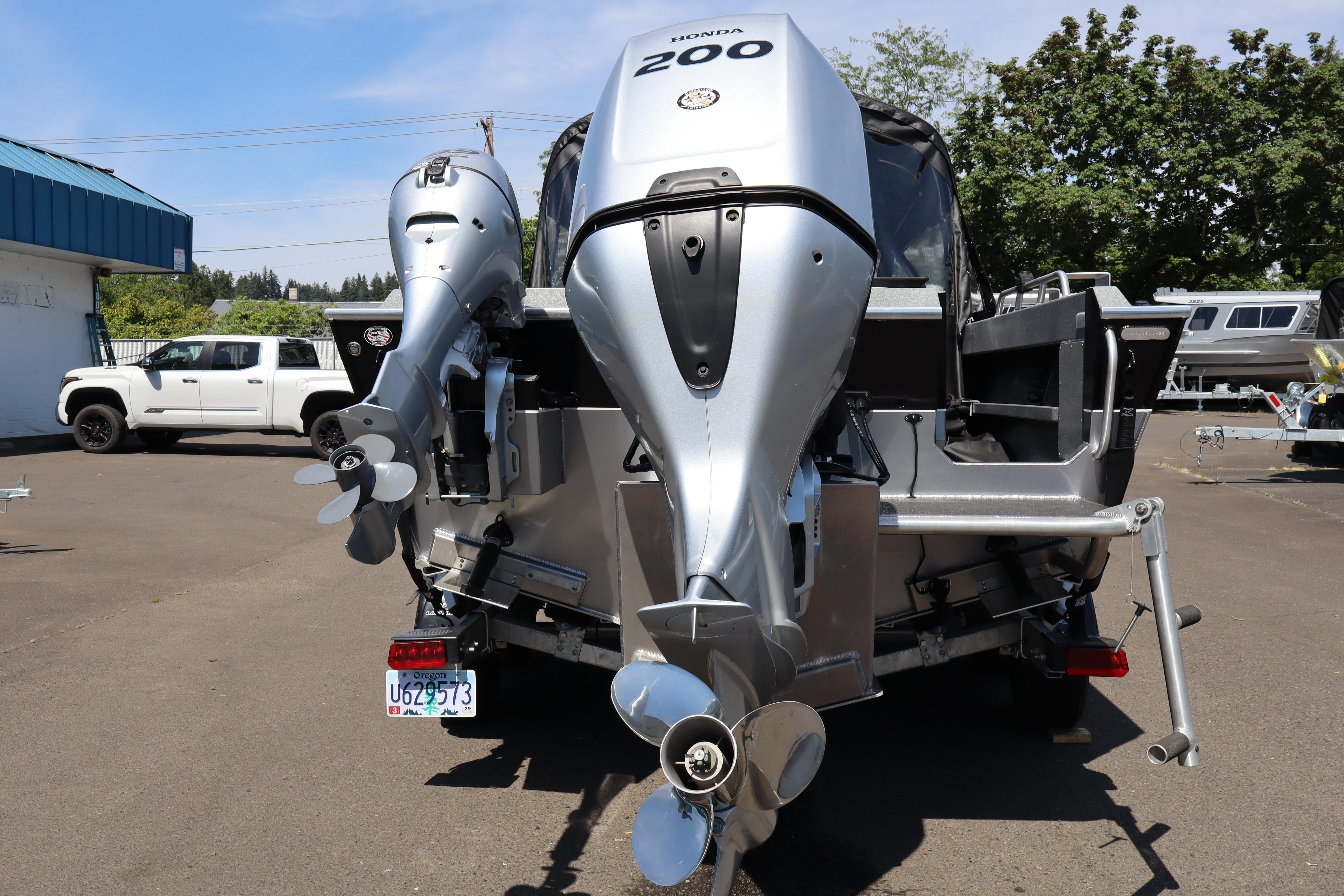 2025 NorthRiver SEAHAWK boat with dual Honda outboard motors in a parking lot.
