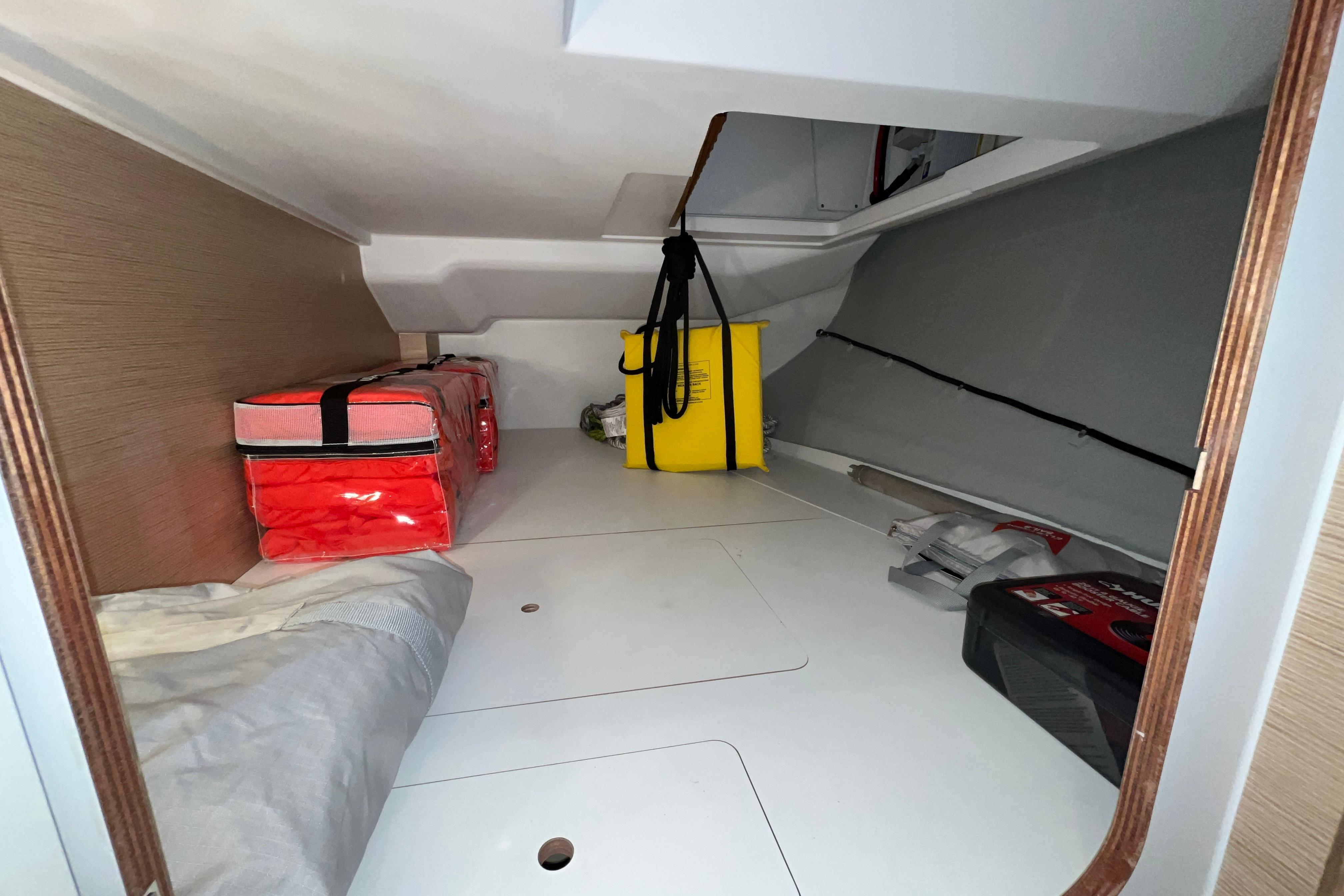 Storage compartment in 2025 Hanse 360 yacht with safety equipment and supplies.