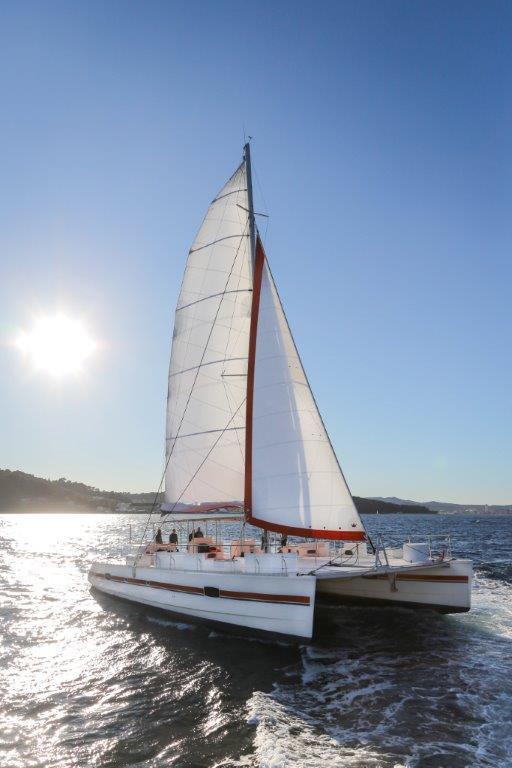 Sailing Catana Taino 21 Day Charter 2025 on sunny ocean waters.