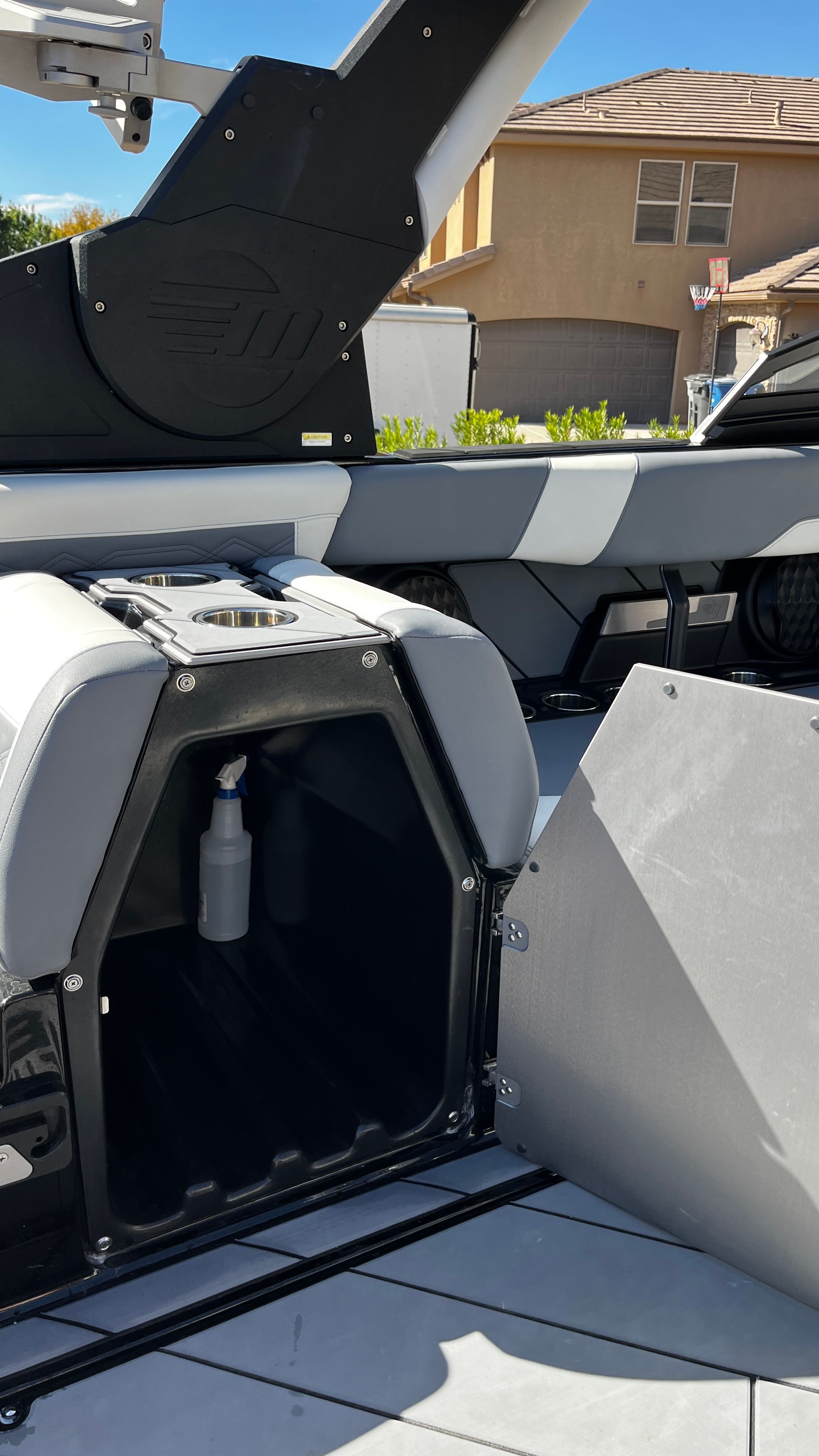 The image shows the interior of a Malibu Wakesetter 26 LSV with storage and cup holder.