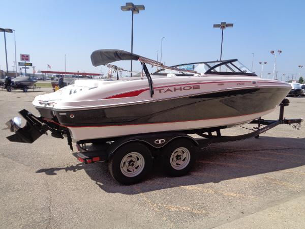 2023 Tahoe 210 Si boat on a trailer in a parking lot.