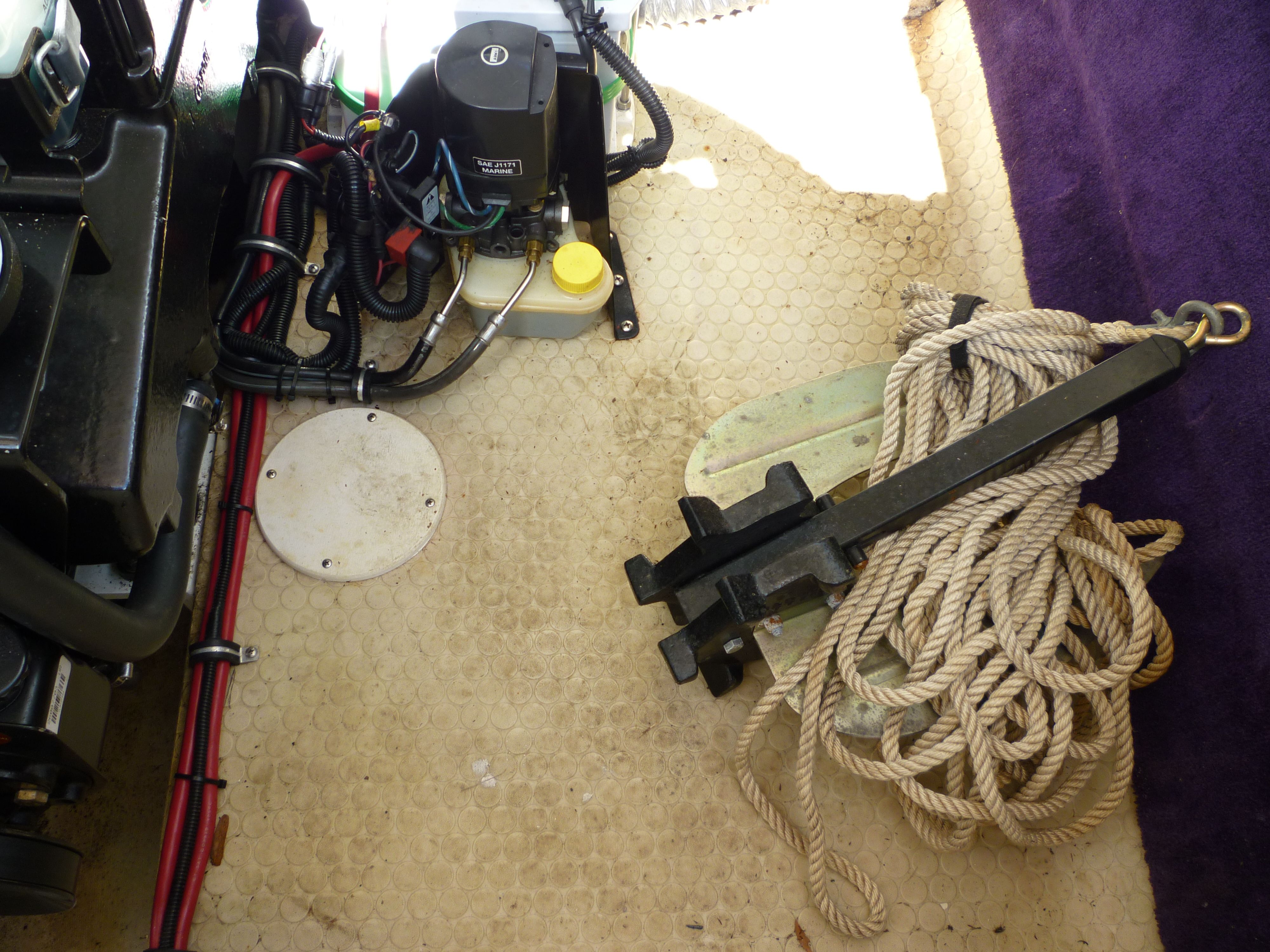 Engine compartment of a 2000 Velocity 280 boat with anchor and rope.