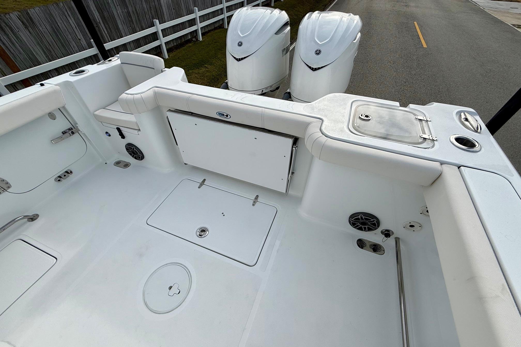2026 Sea Hunt Gamefish 30 Coffin Box boat interior with dual engines and storage compartments.