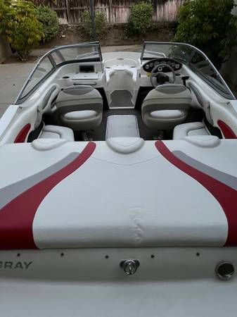 Interior view of a 2006 Stingray 195LR bowrider with gray and red seating.