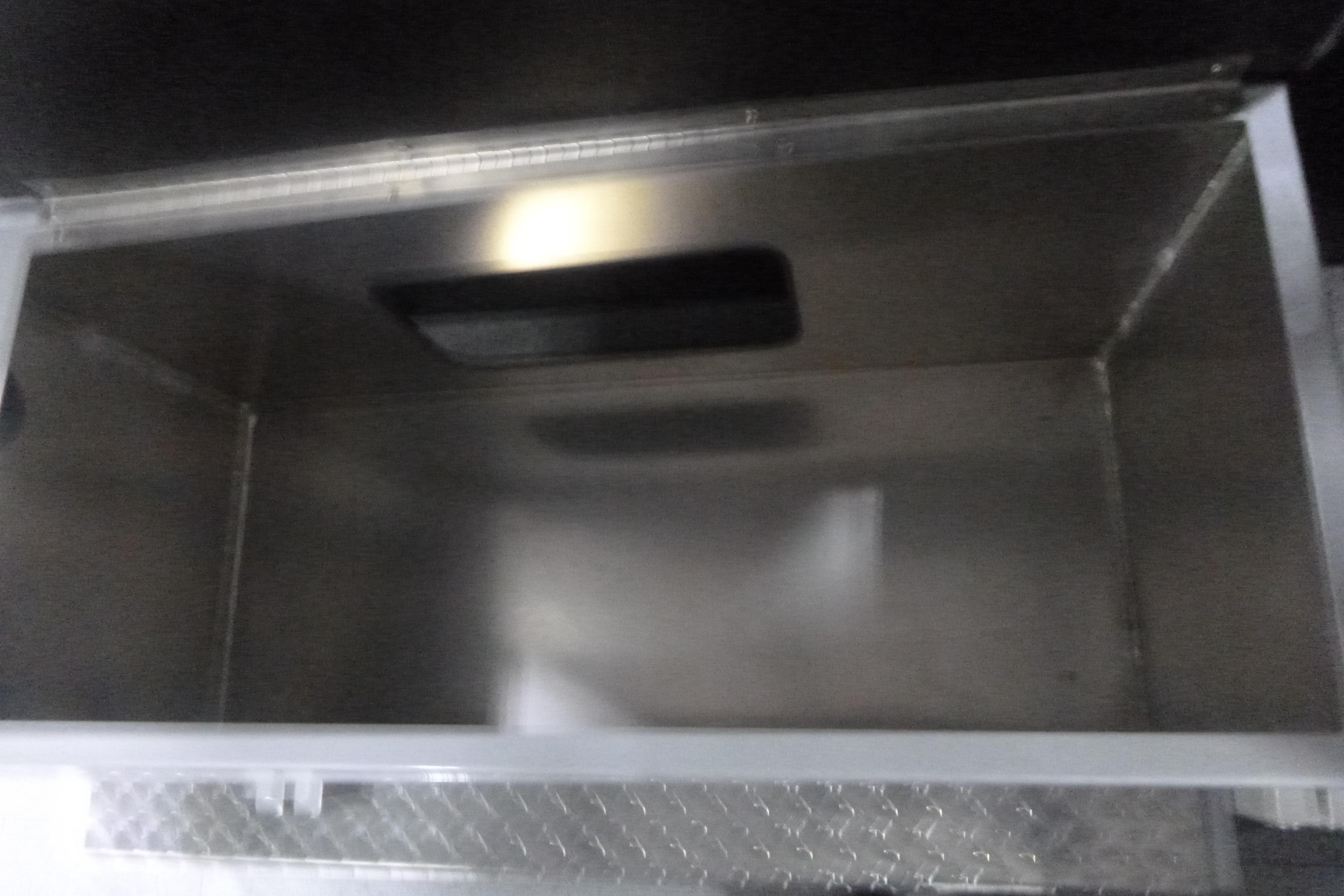 Storage compartment of 2026 KingFisher 2425 Escape HT boat, featuring a metallic interior.