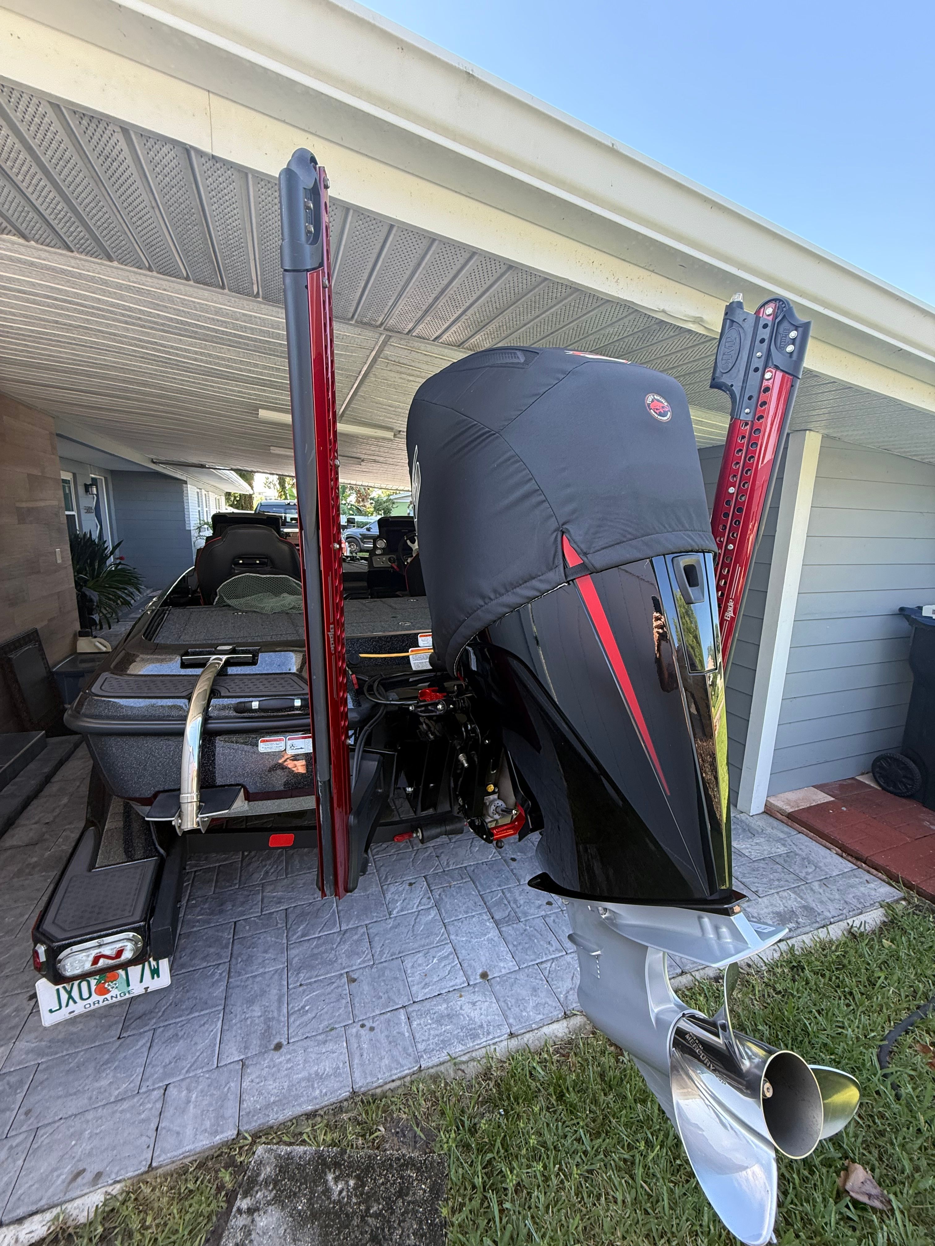 A 2024 Nitra Boats 21 XL Pro on a trailer under a carport.