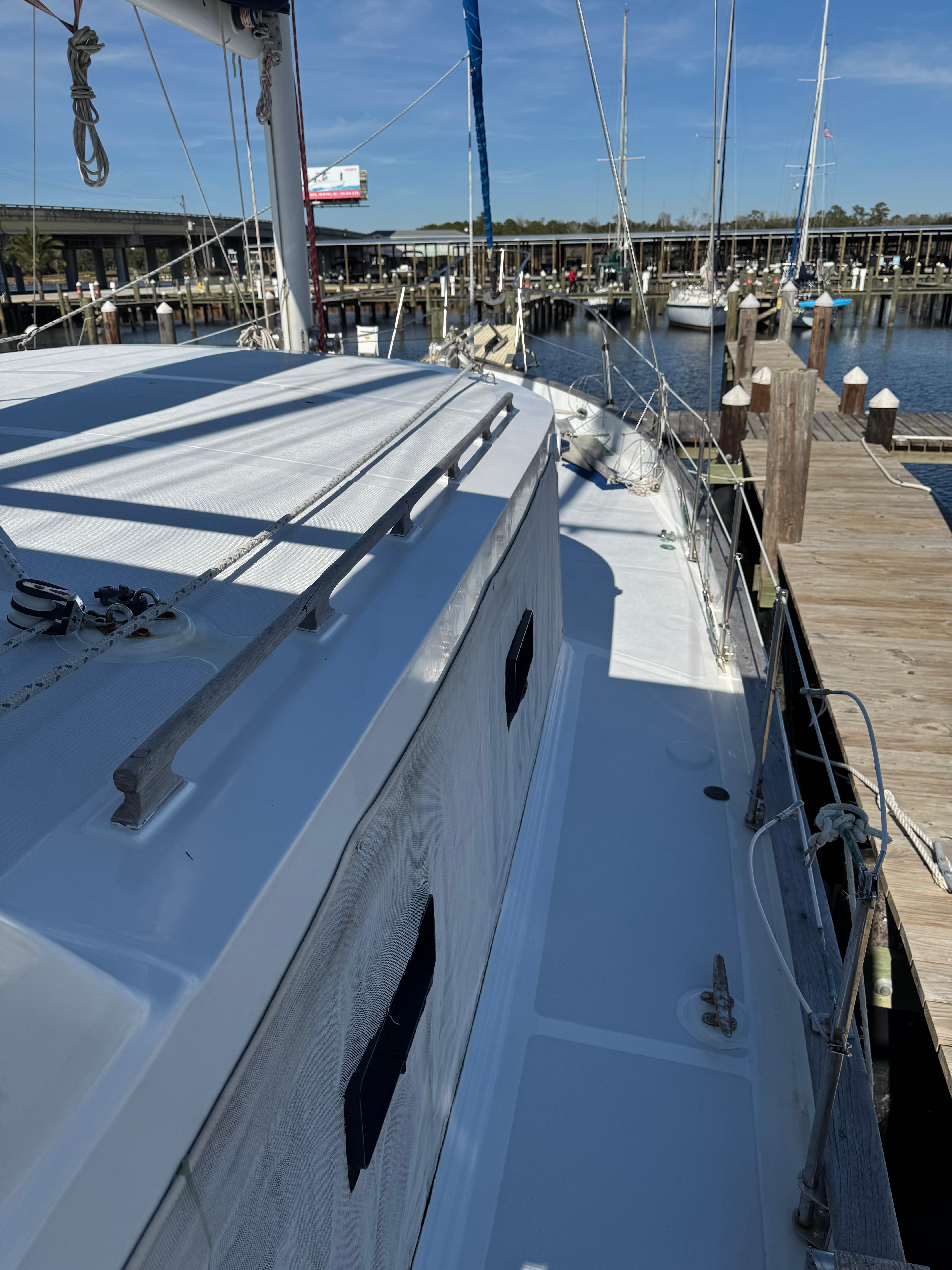 1983 Island Trader Motor Sailor docked at marina, showcasing deck and railing.