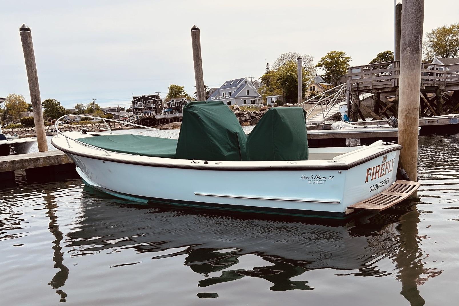 1999 Northshore 22 boat docked in a marina, named "Firefly" from Gloucester.