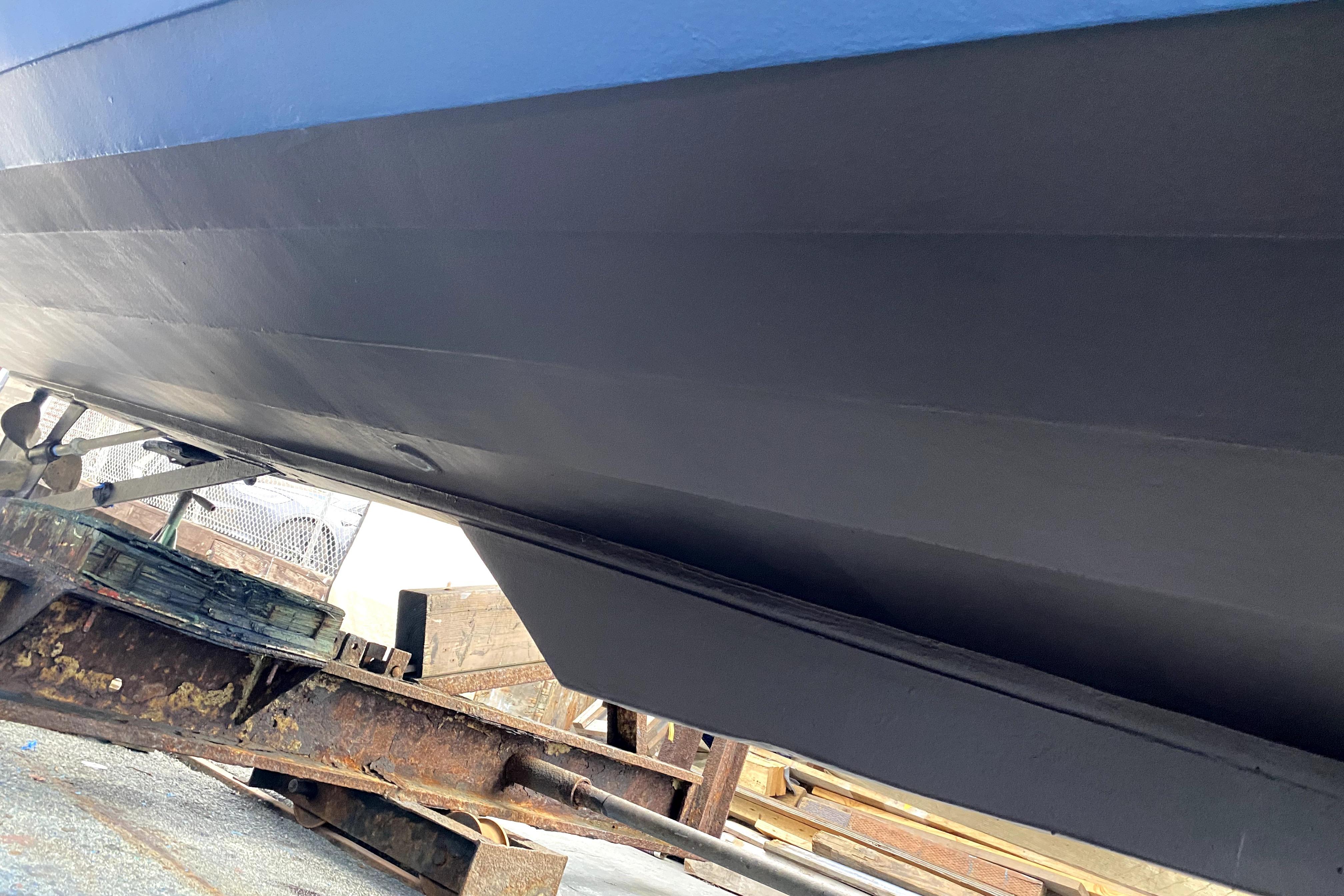 1964 Lyman 25 Sleeper boat hull on trailer, showcasing underside details.