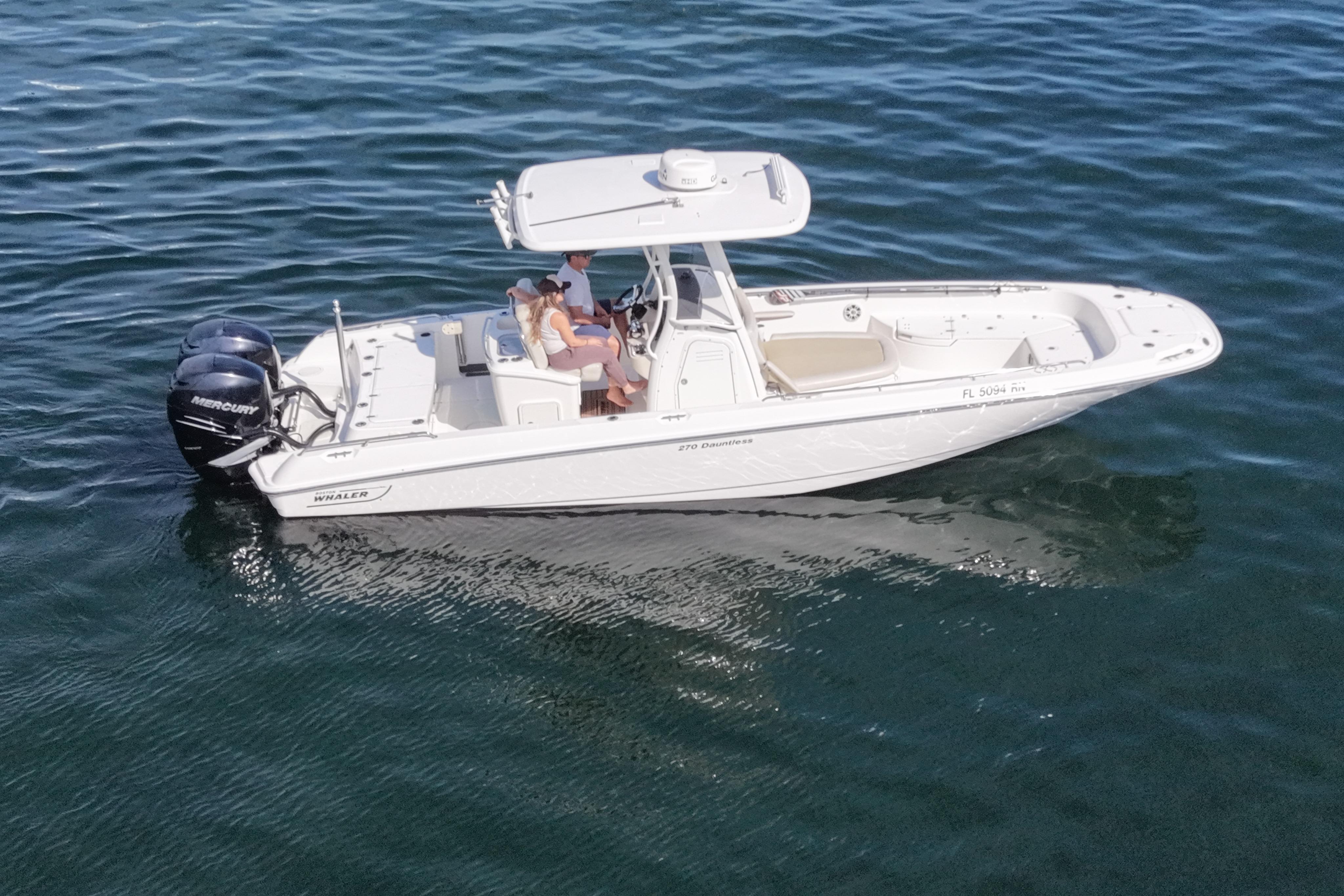 2018 Boston Whaler 270 Dauntless boat on water, featuring dual Mercury engines.