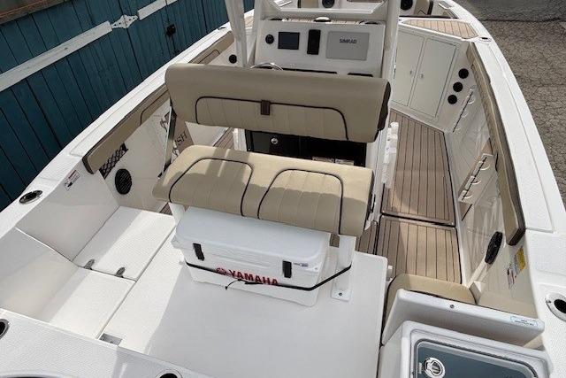 2026 Yamaha Boats 222 FSH Sport E interior with beige seating and modern console.