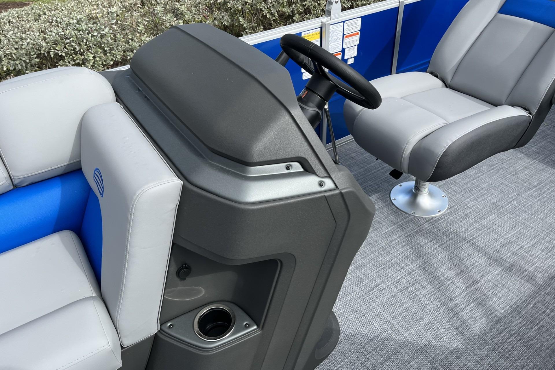 2026 Sun Tracker Party Barge 20 DLX interior with steering console and seating.