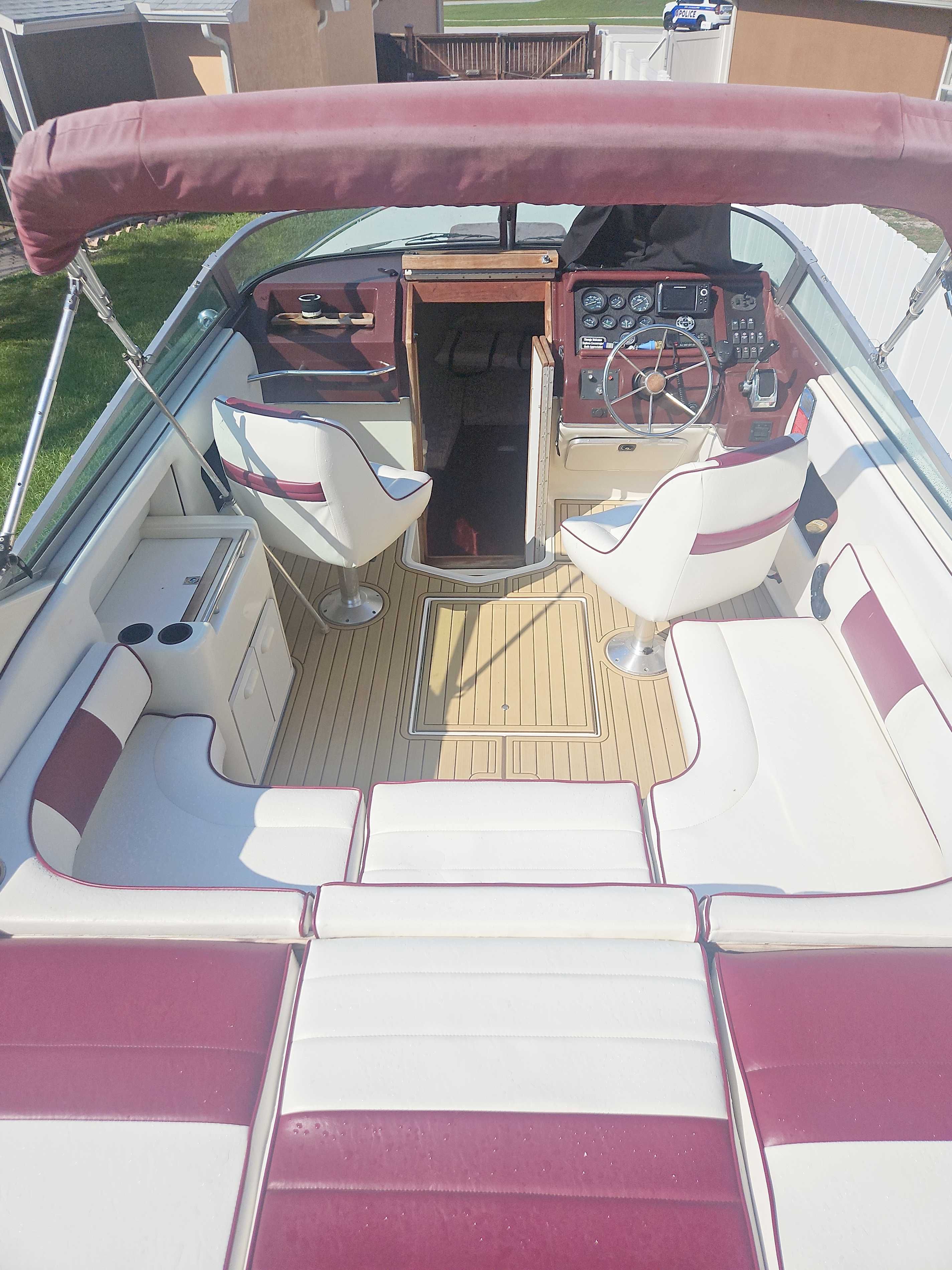 The image shows the cockpit of a 1989 Sea Ray 260 Overnighter with red and white seating.