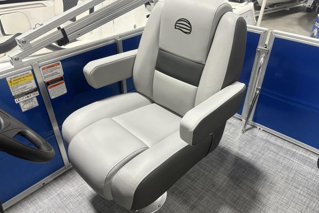 2026 Sun Tracker Party Barge 16 DLX captain's chair, gray upholstery, blue panel background.