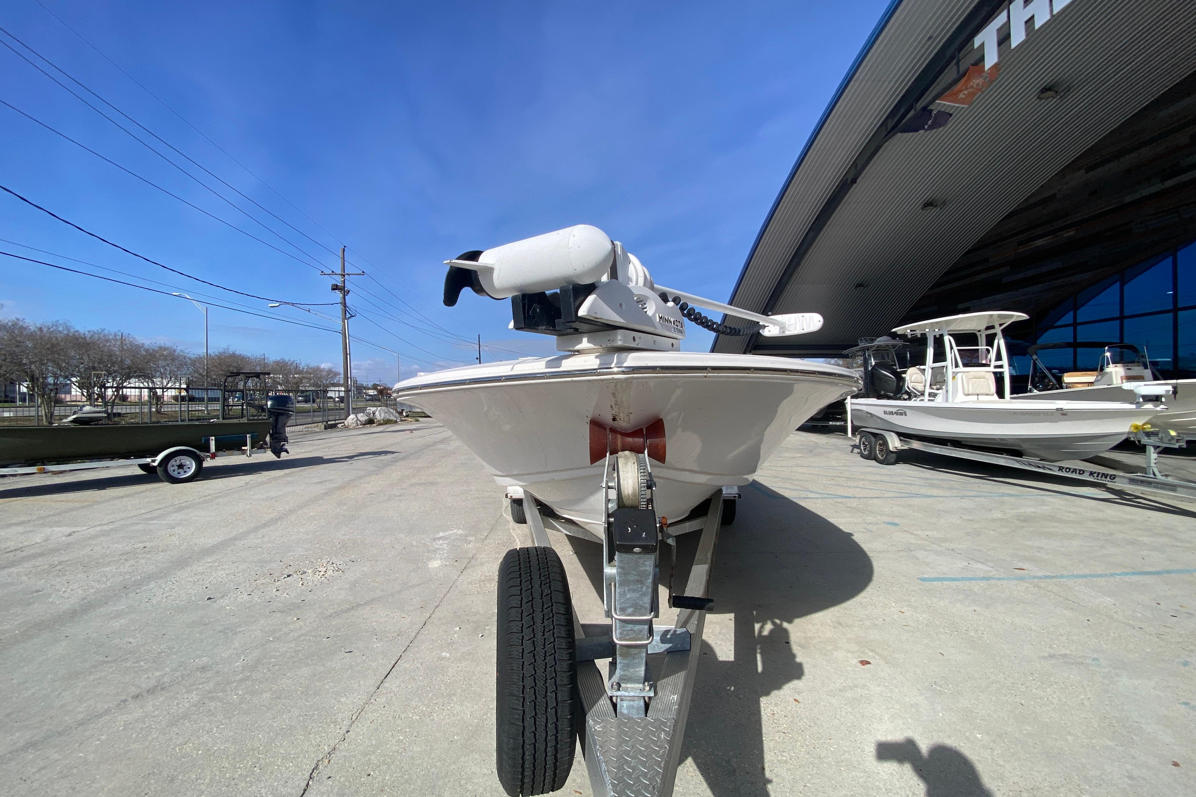 2023 Tidewater 2410 Bay Max boat on trailer outside dealership.