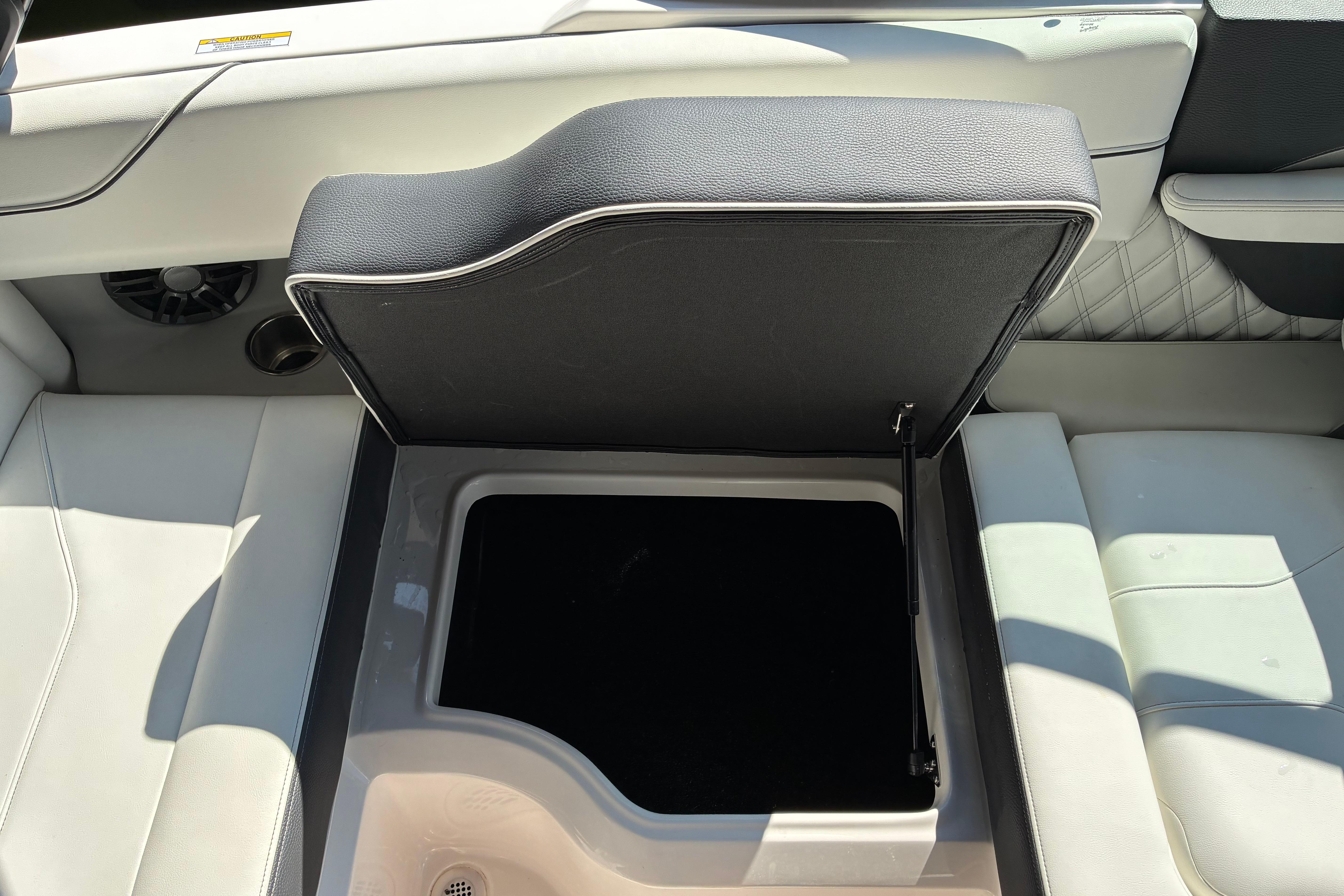 2025 Regal LS2 boat interior storage compartment with open lid, showcasing sleek design.