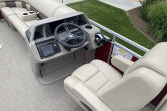 2024 Sun Tracker Party Barge 22 DLX boat interior with steering console and seating.