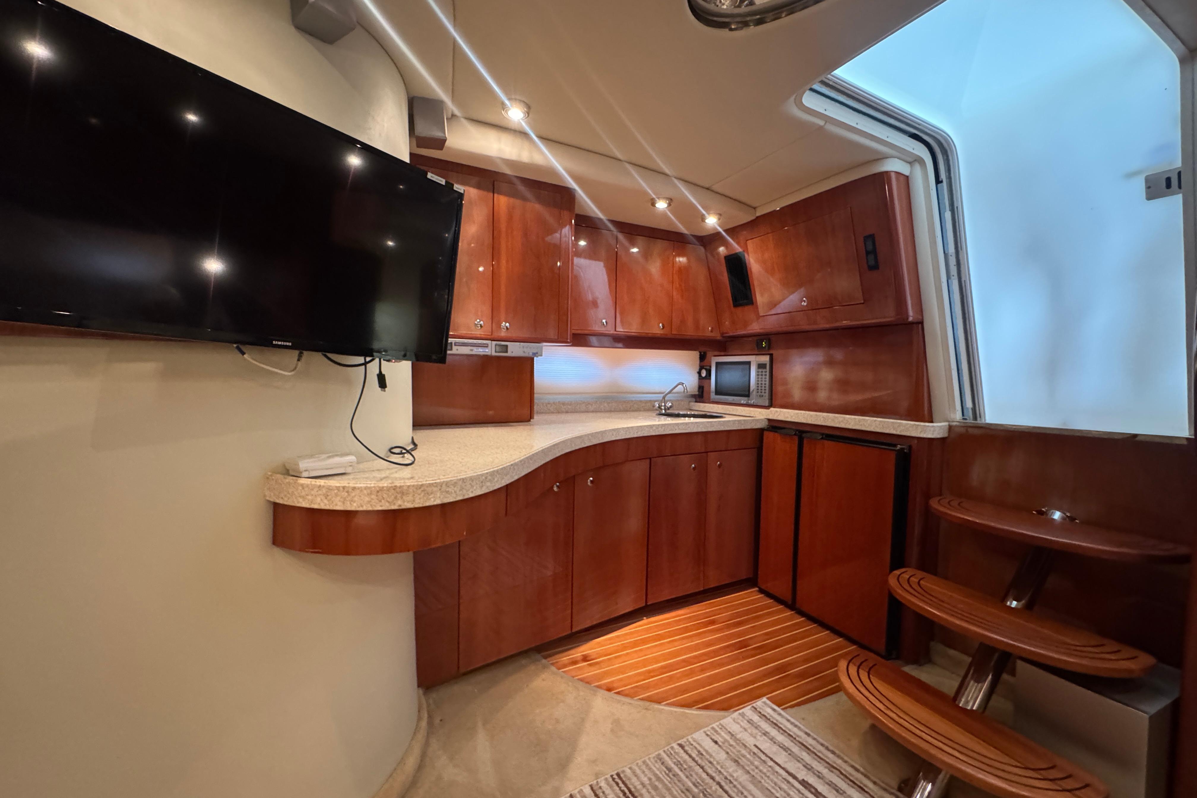 Luxurious 2005 Regal Commodore 4260 yacht interior with modern kitchen and entertainment area.
