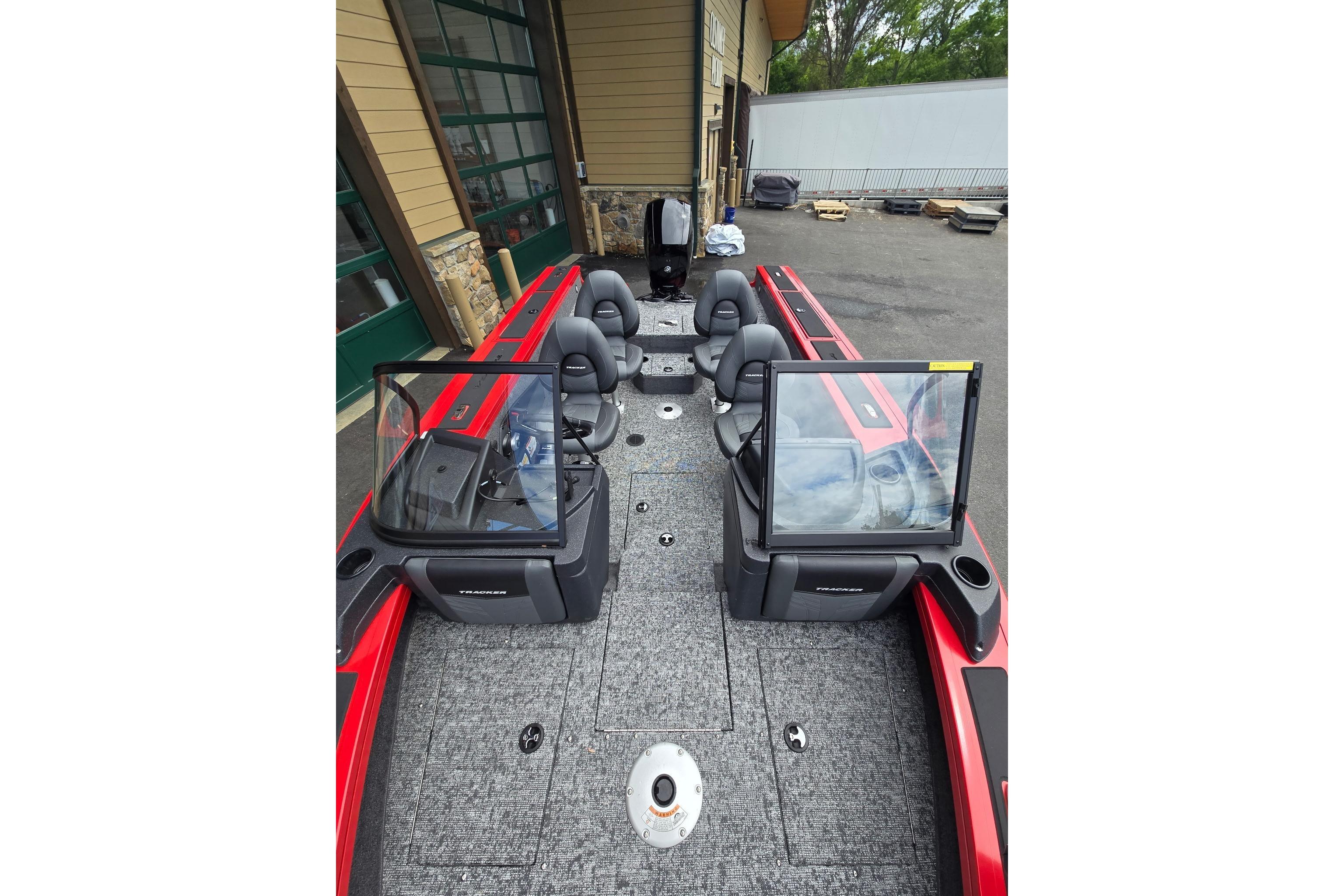 2026 Tracker Targa V-18 WT boat interior with seating and windshield, parked outdoors.