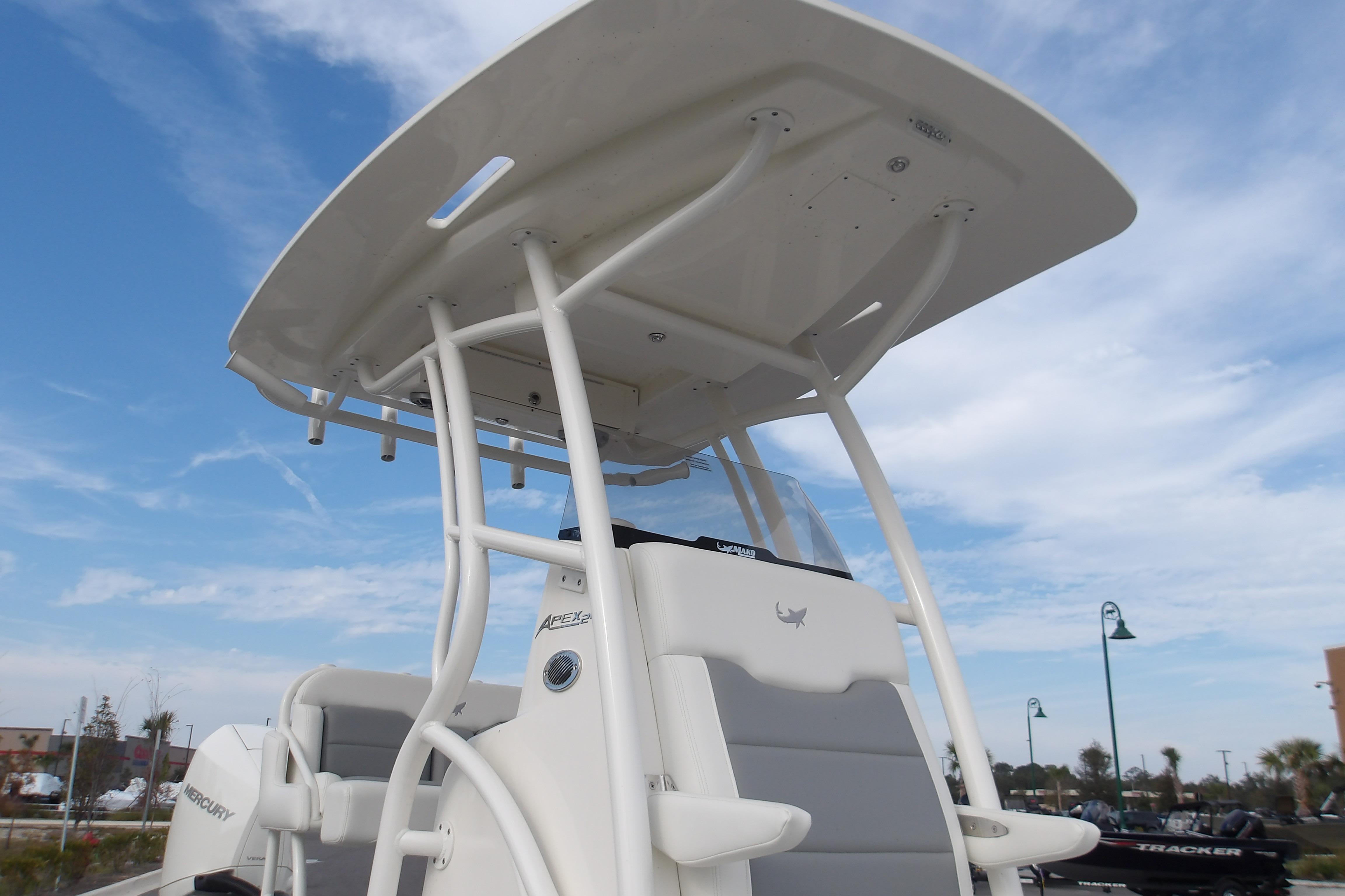 2026 Mako 24 APEX boat with T-top against a clear blue sky.