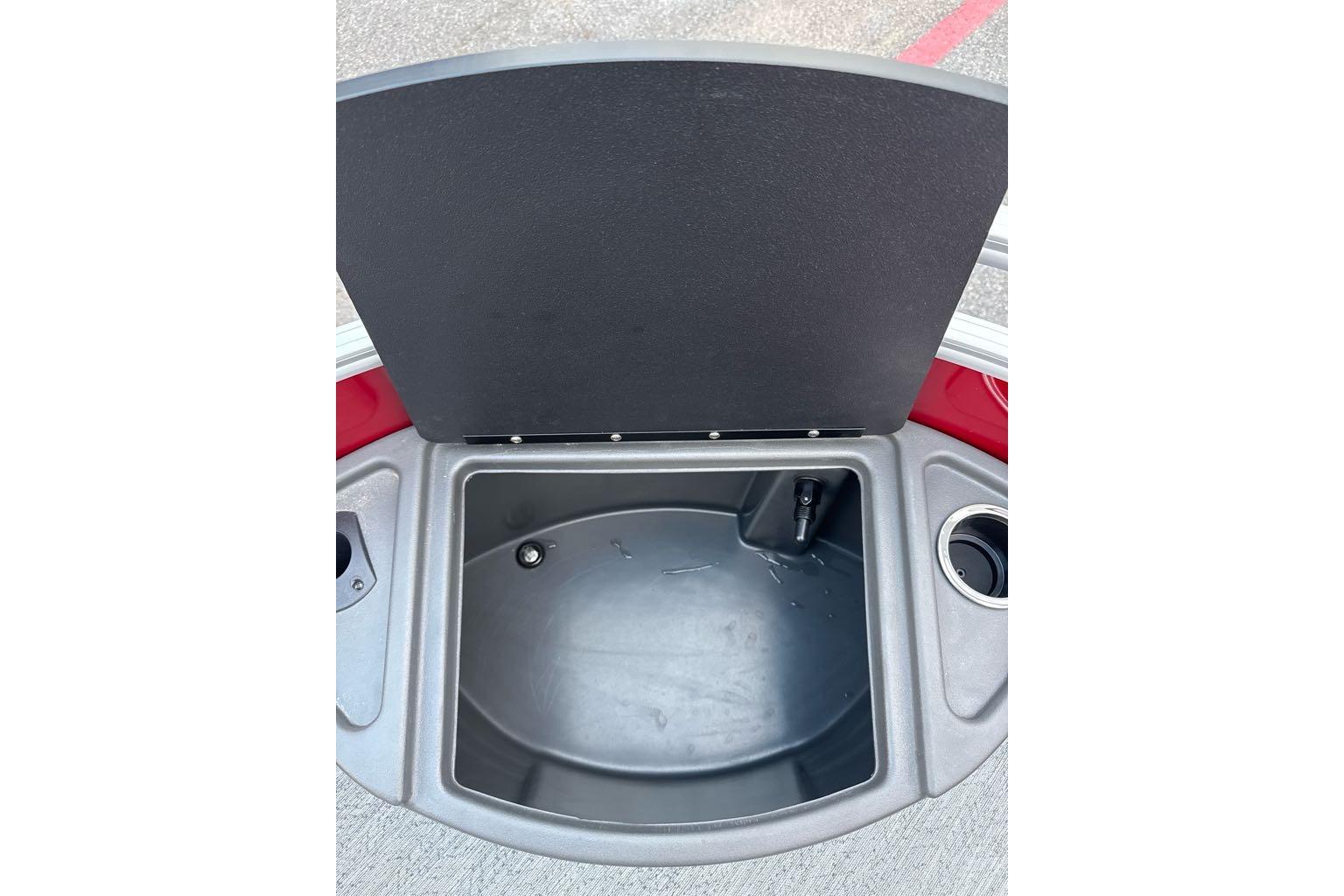 Open storage compartment on 2026 Sun Tracker Fishin' Barge 22 DLX boat.