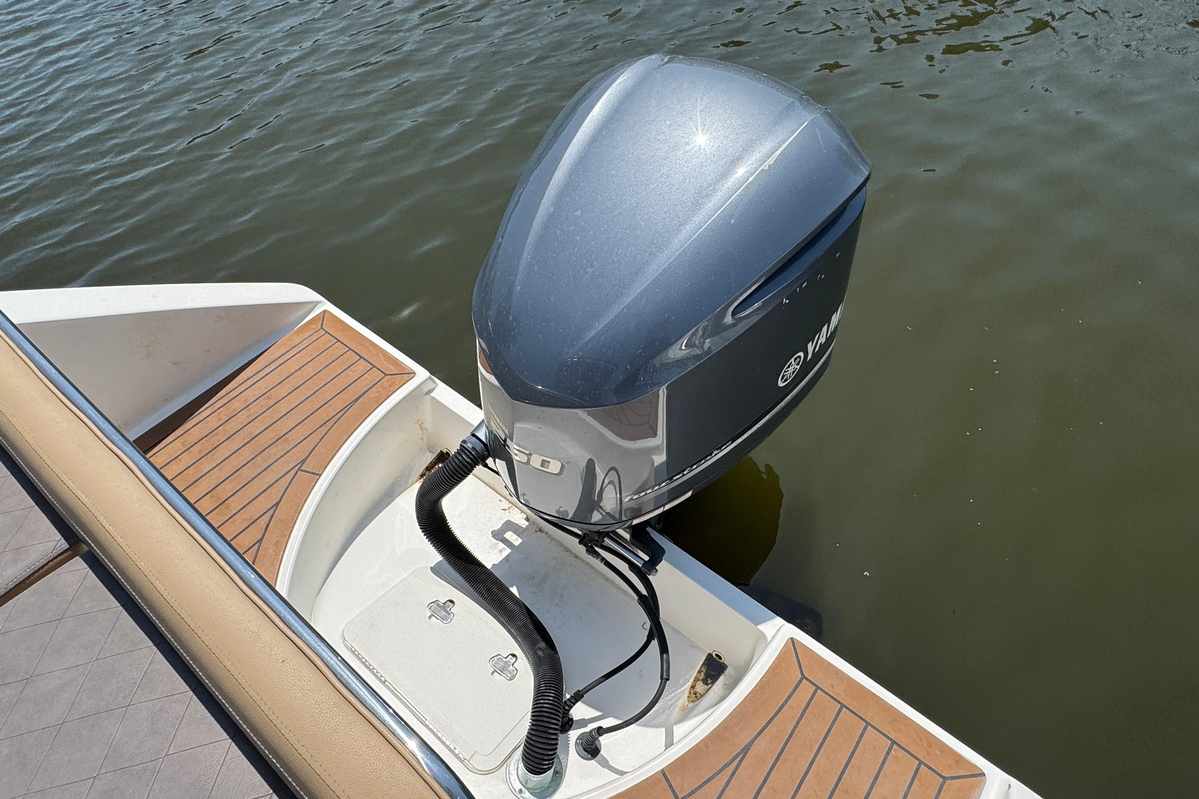 Century 2301 Center Console 2014 boat with Yamaha outboard motor on calm water.